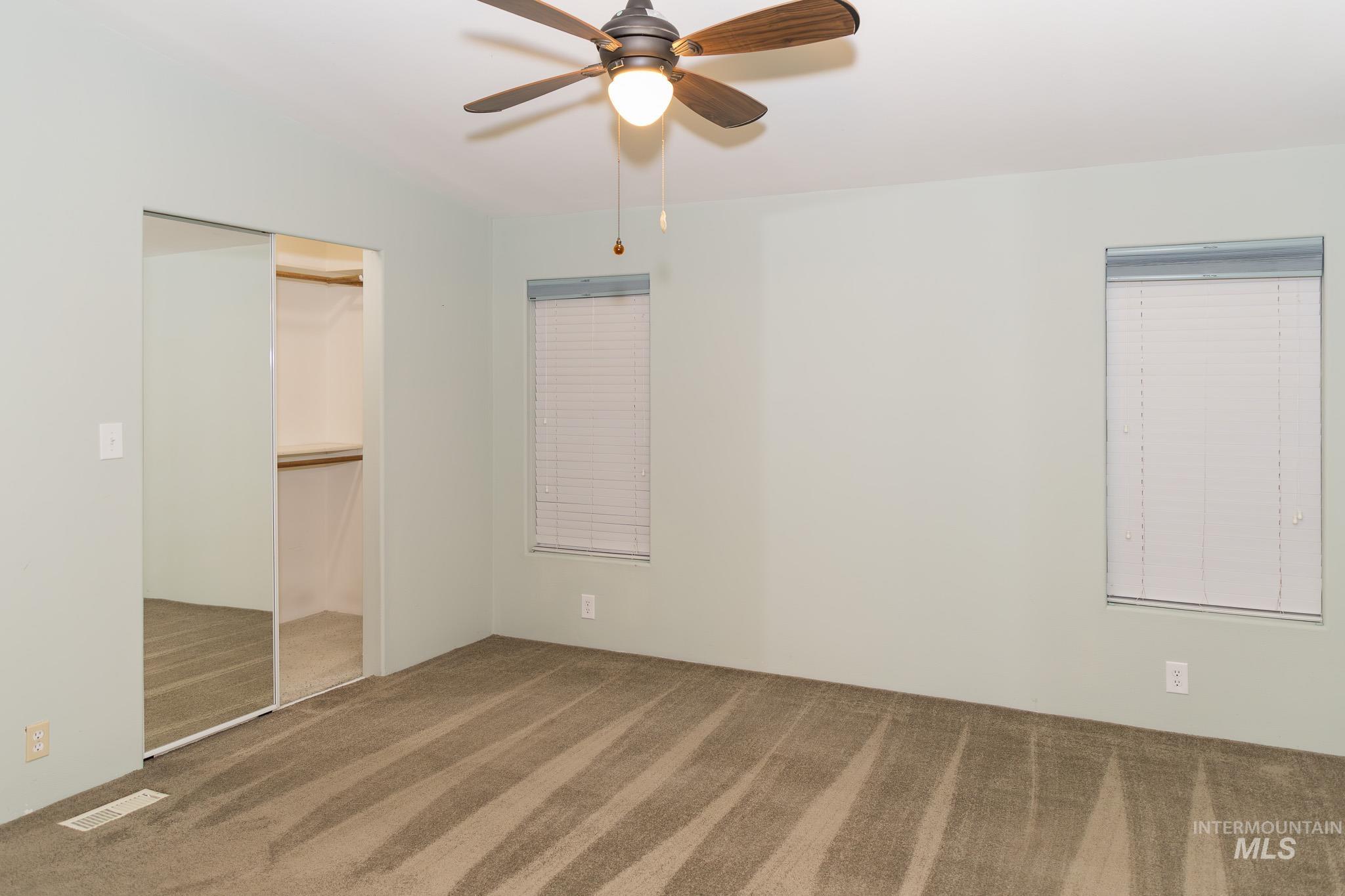Unfurnished bedroom featuring carpet, a closet, and ceiling fan