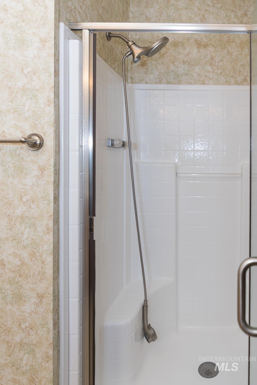 Full bath featuring a shower stall