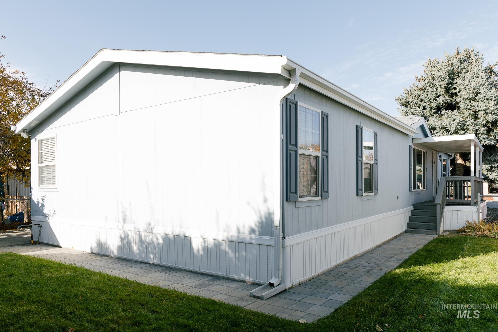 View of property exterior with a yard