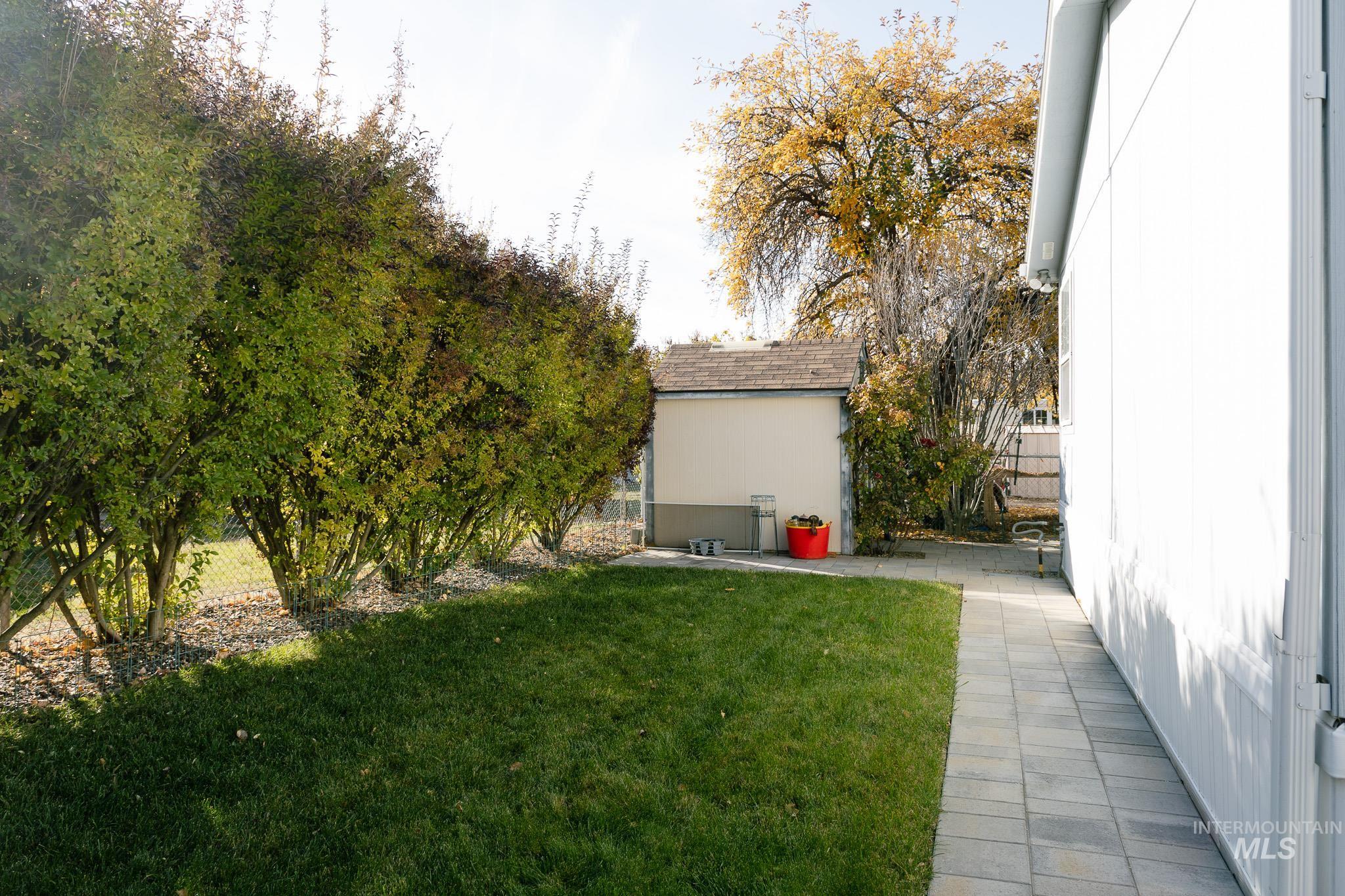 View of yard featuring an outdoor structure and a patio