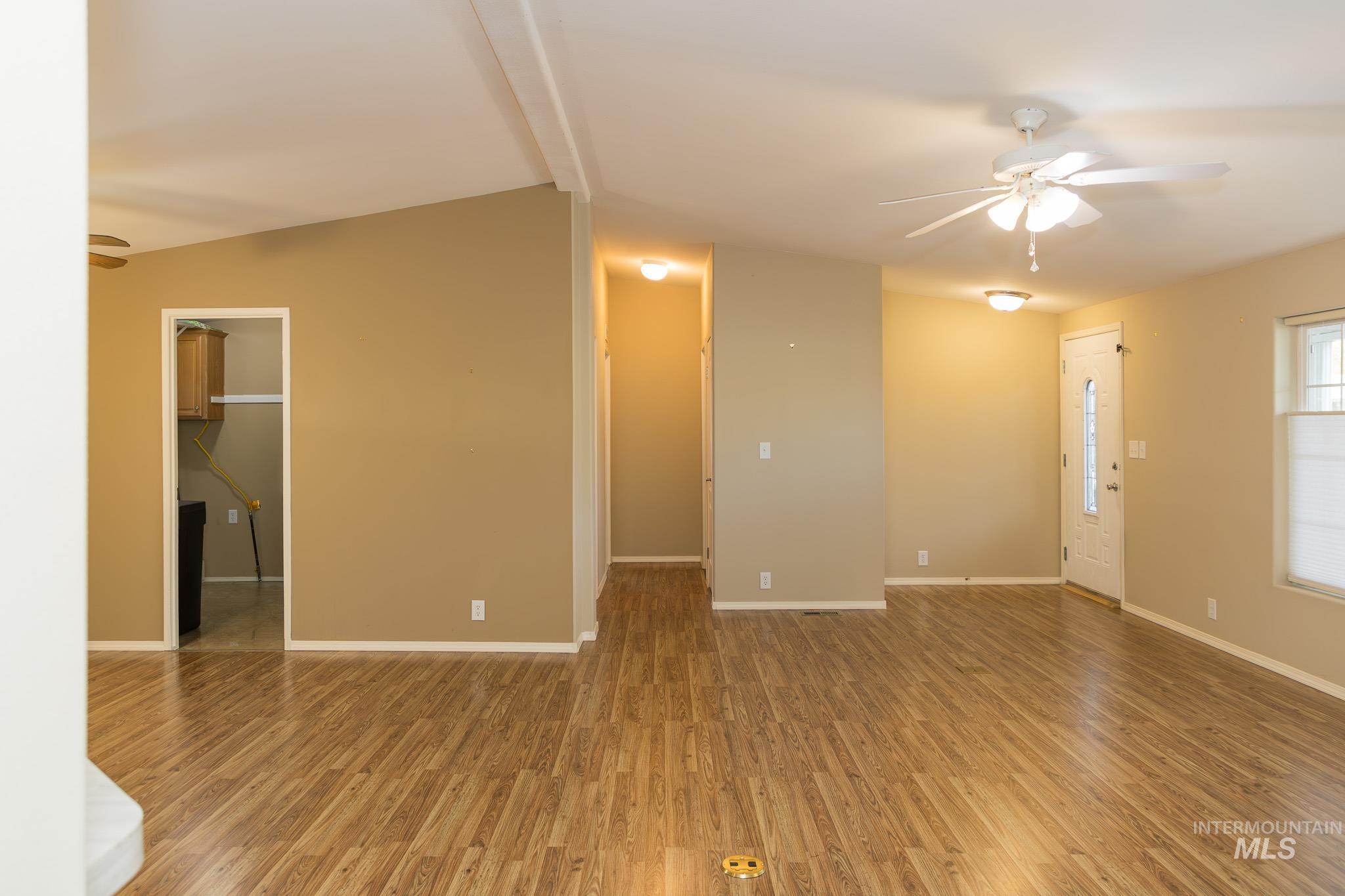 Unfurnished living room featuring a ceiling fan and light wood finished floors
