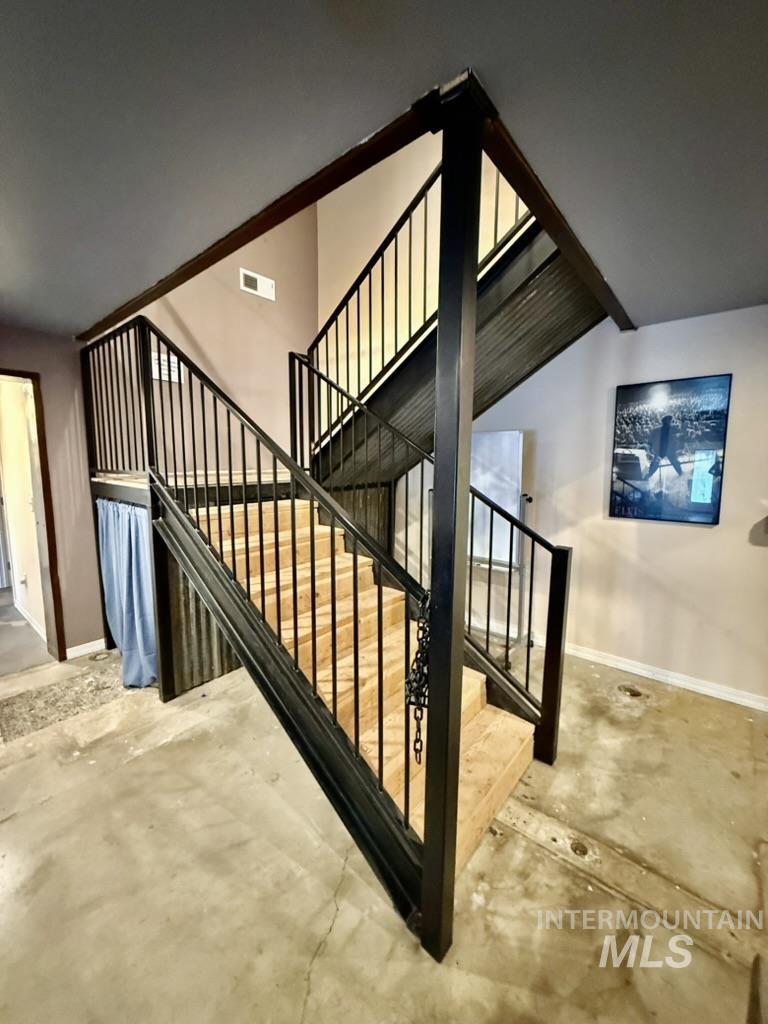 Stairs featuring concrete floors