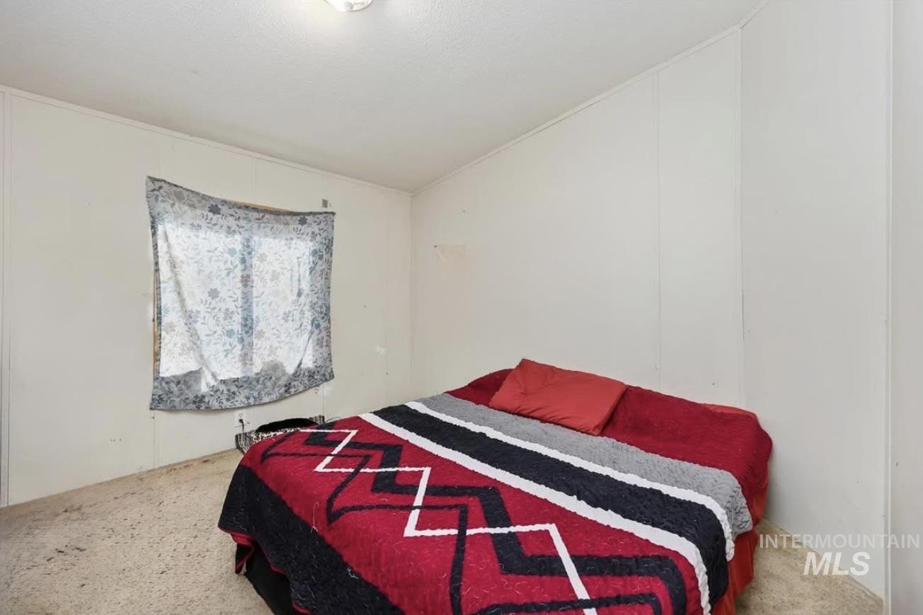Bedroom with carpet flooring and vaulted ceiling