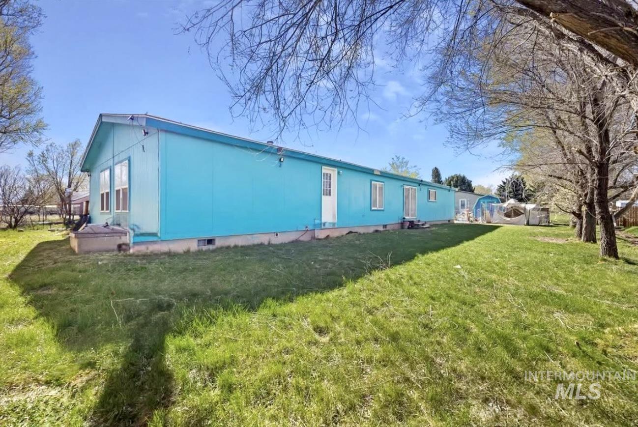 Rear view of house with a lawn