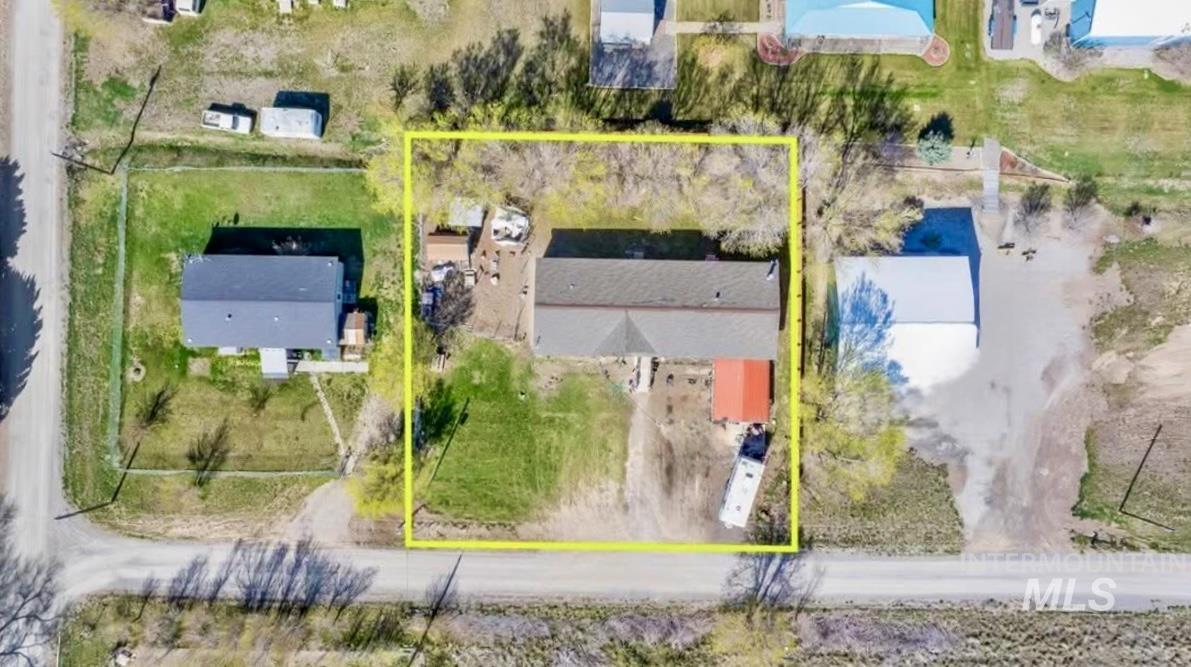 Aerial view of property and surrounding area featuring property boundaries highlighted