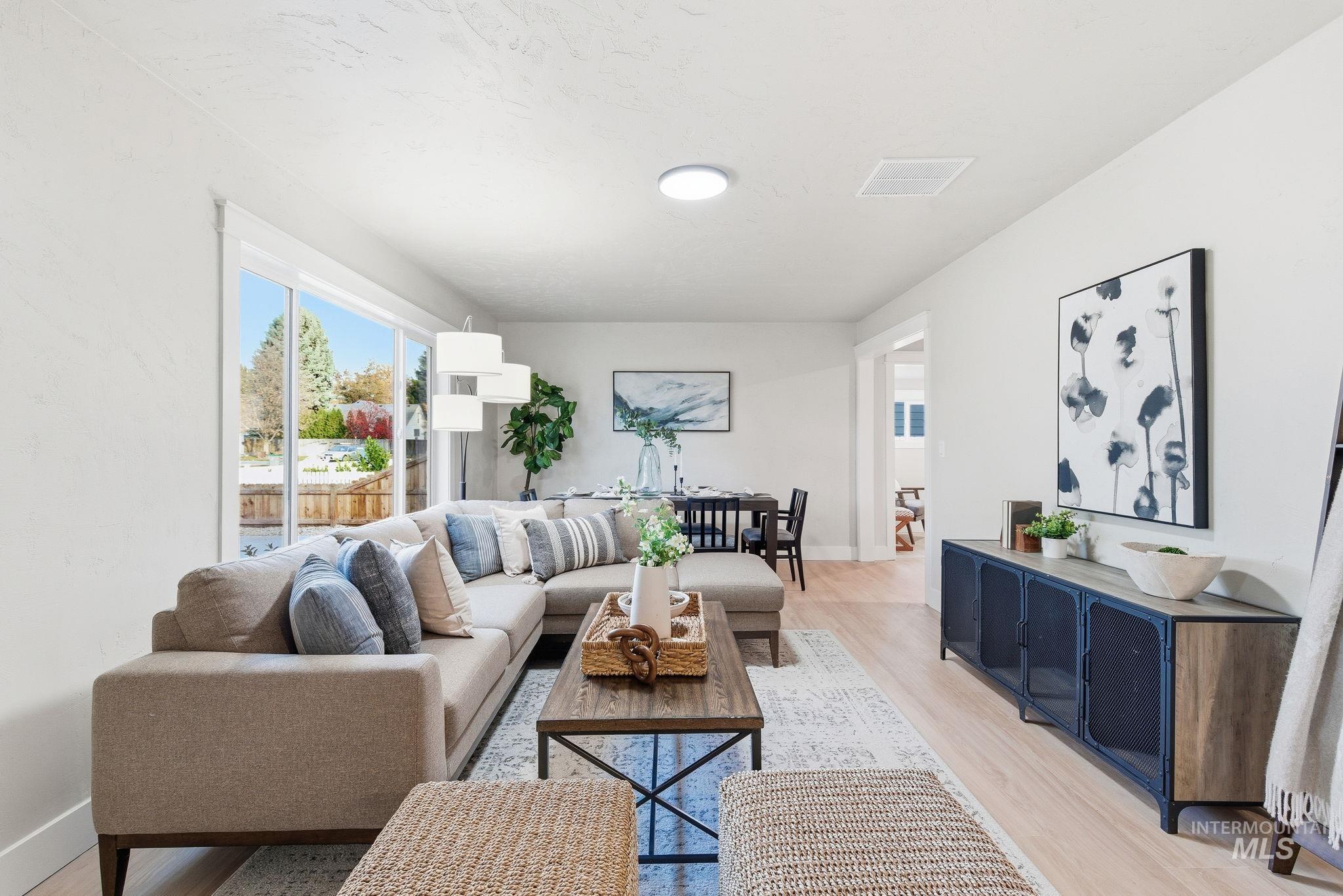 Living area with light wood-style floors and baseboards
