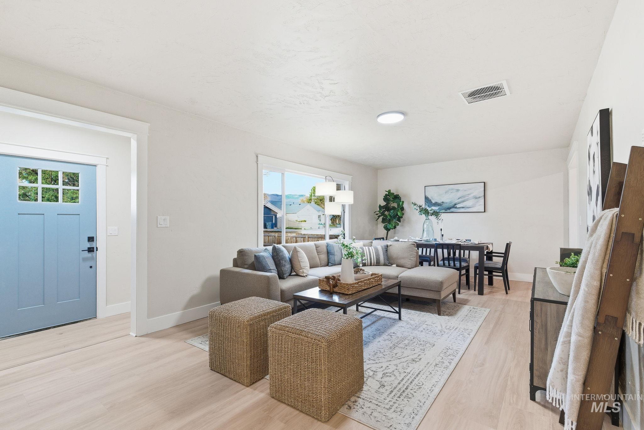 Living area with light wood-style flooring and baseboards