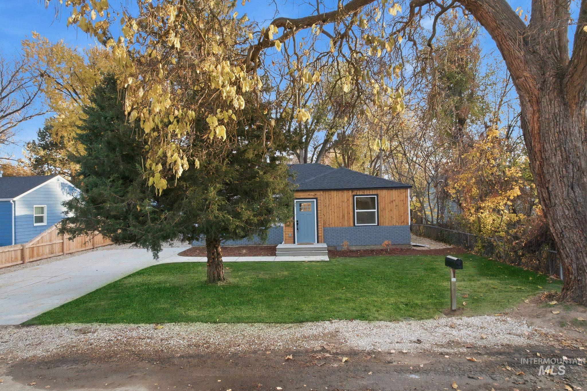 Bungalow featuring a shingled roof and concrete driveway