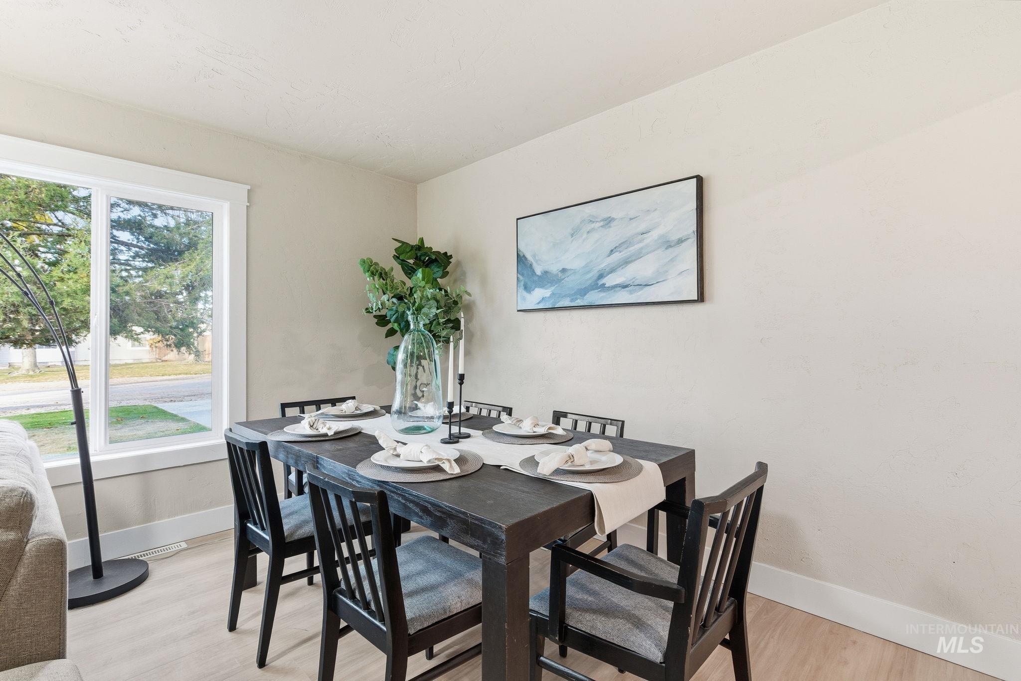 Dining space featuring light wood-type flooring and baseboards