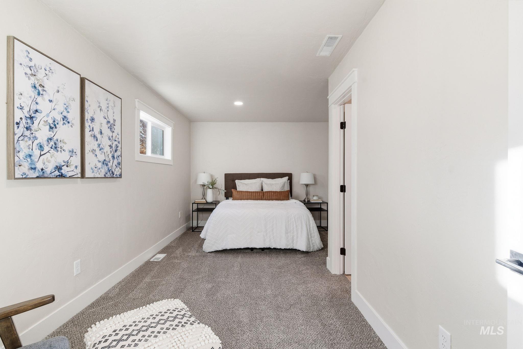 Carpeted bedroom with baseboards