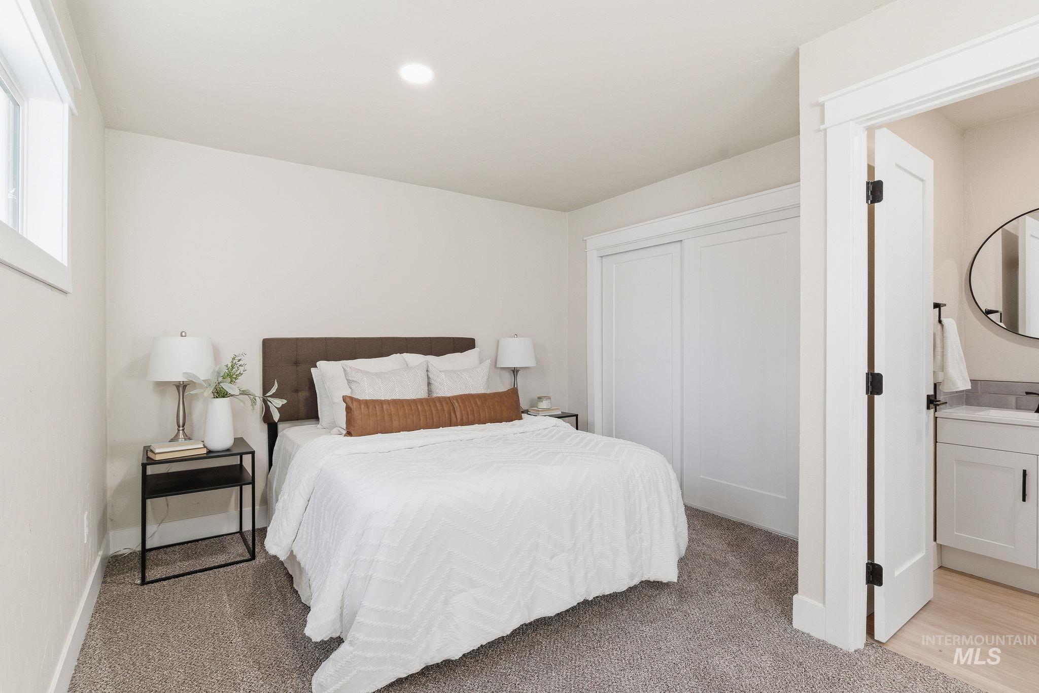 Bedroom with light colored carpet, a closet, and recessed lighting