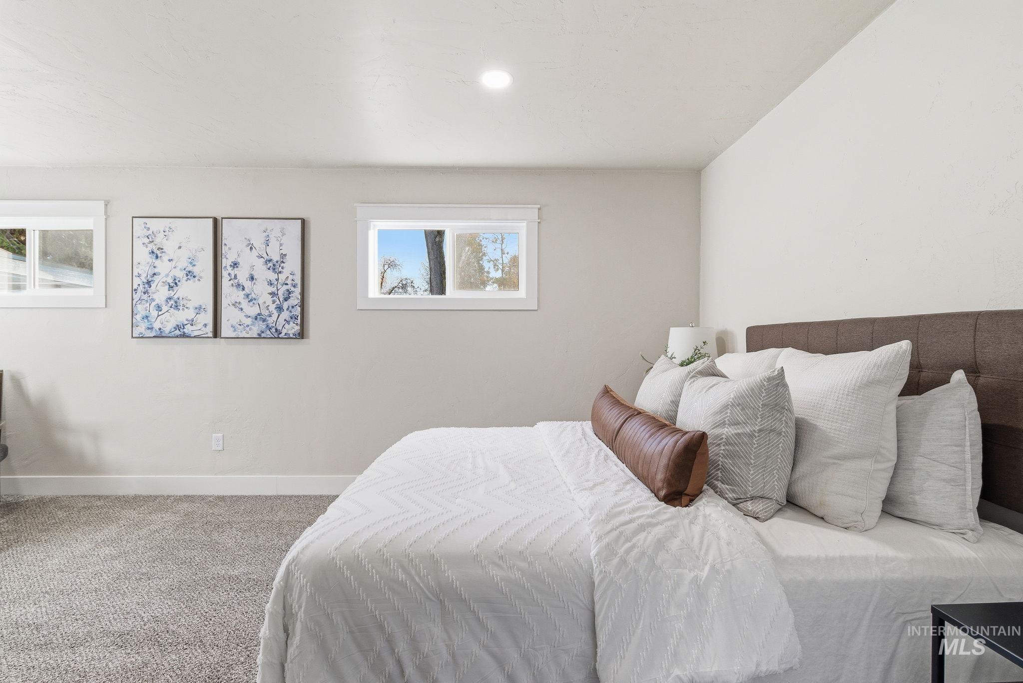 Carpeted bedroom with baseboards
