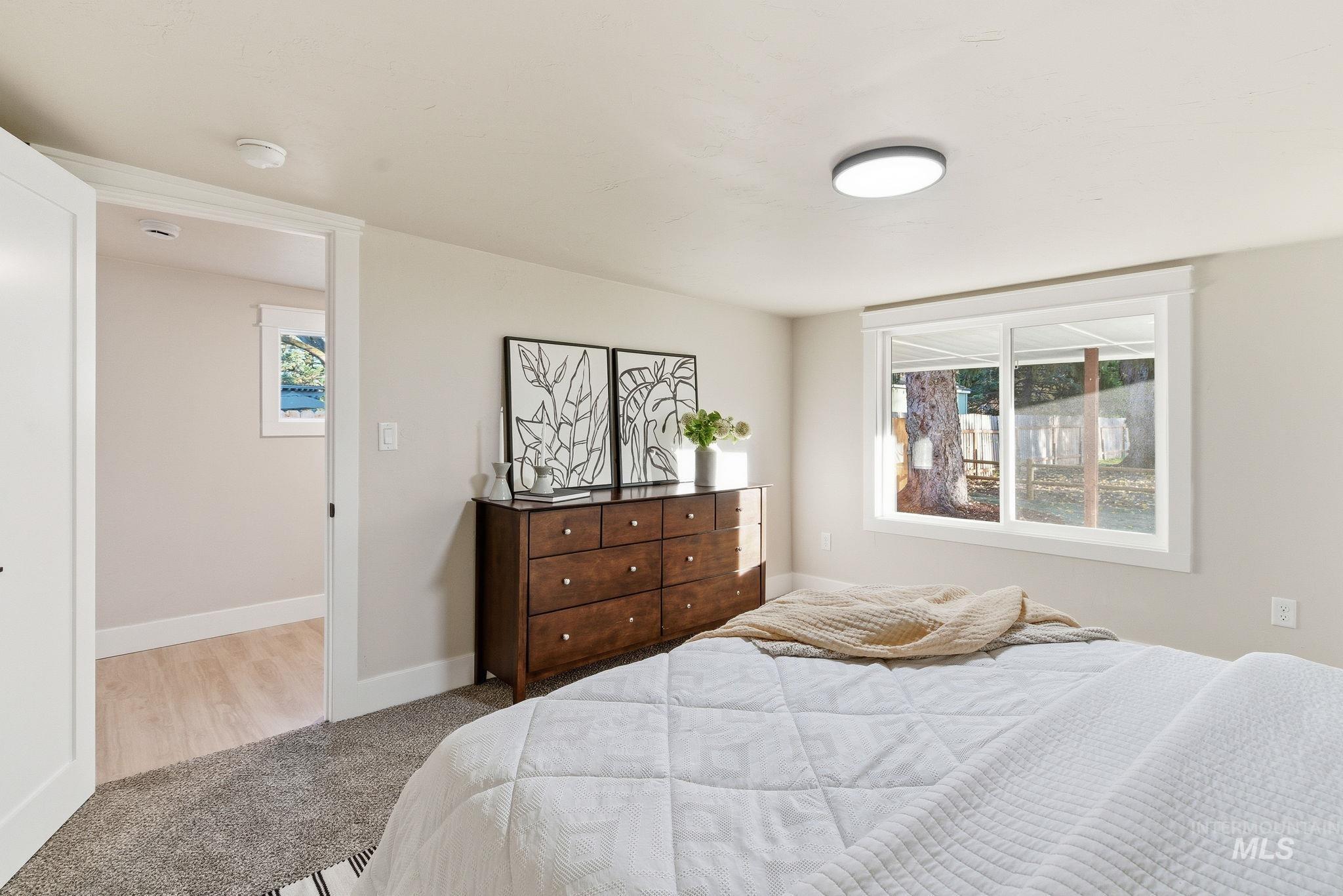 Bedroom with carpet flooring and baseboards
