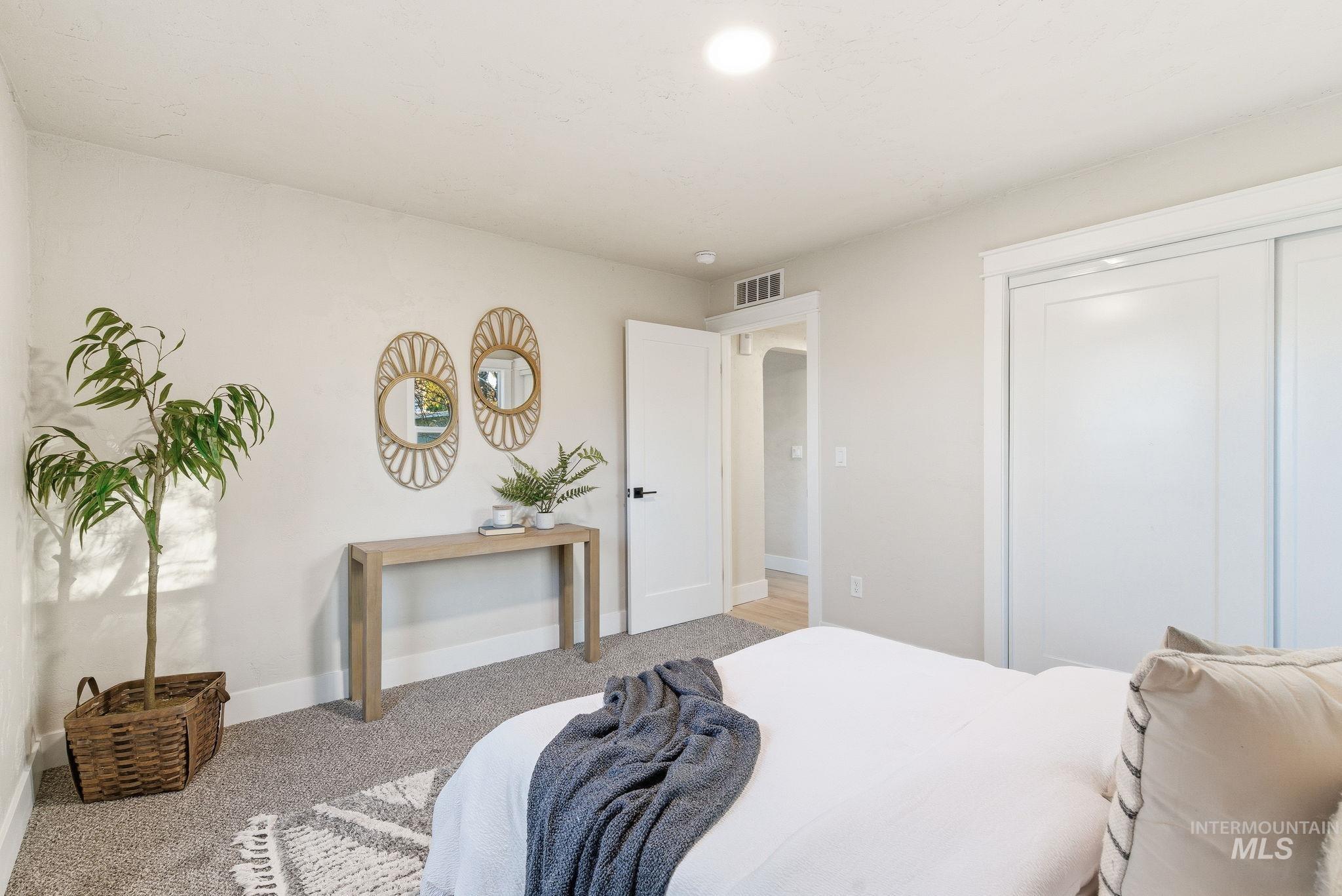 Bedroom featuring carpet flooring and a closet