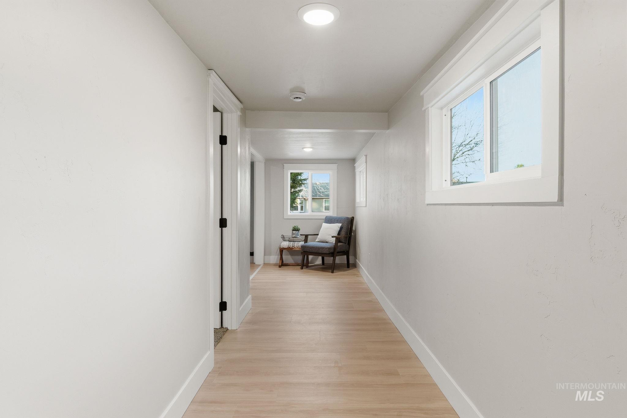 Hall featuring light wood-style flooring and recessed lighting