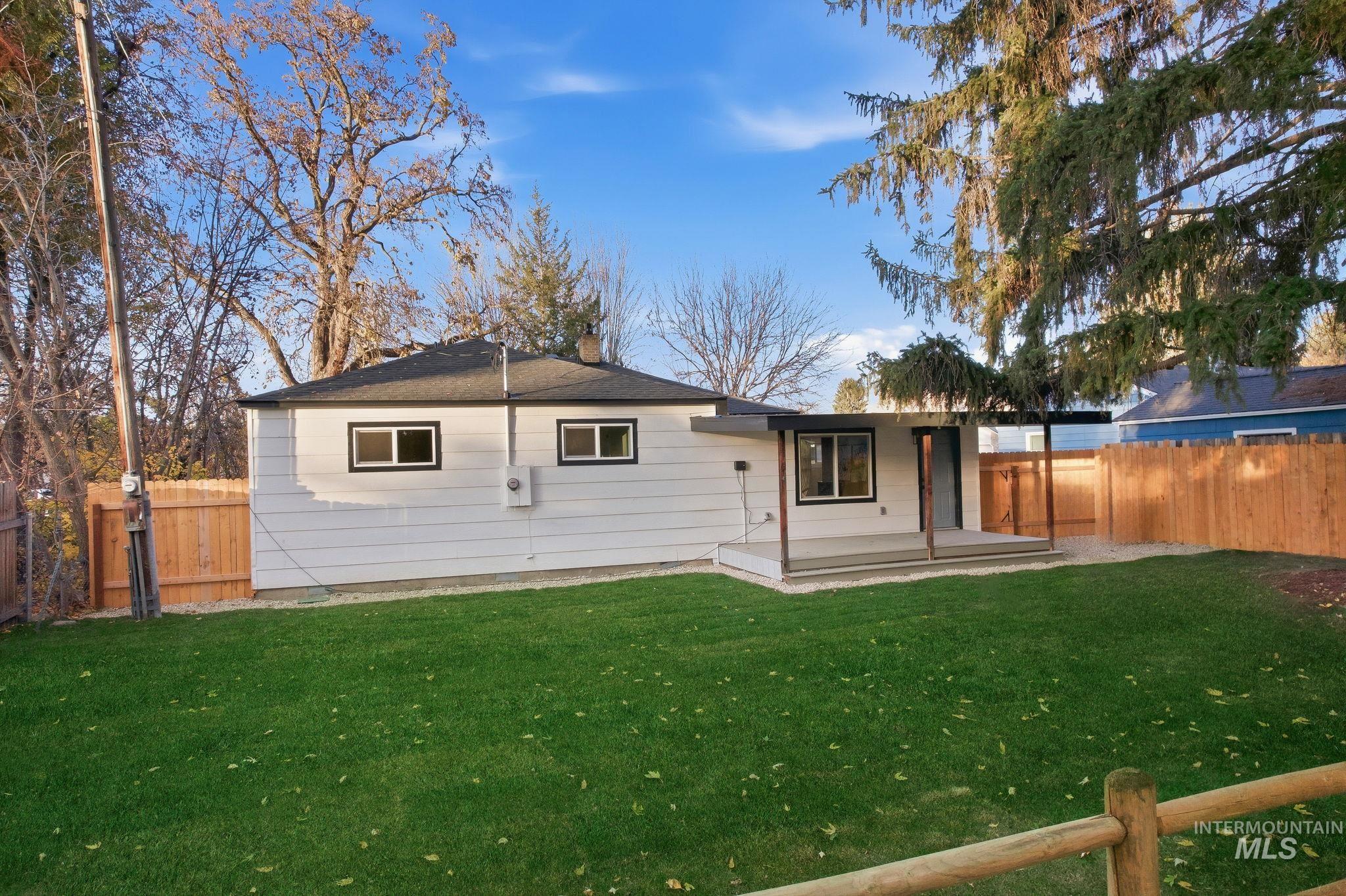 Back of property with a fenced backyard