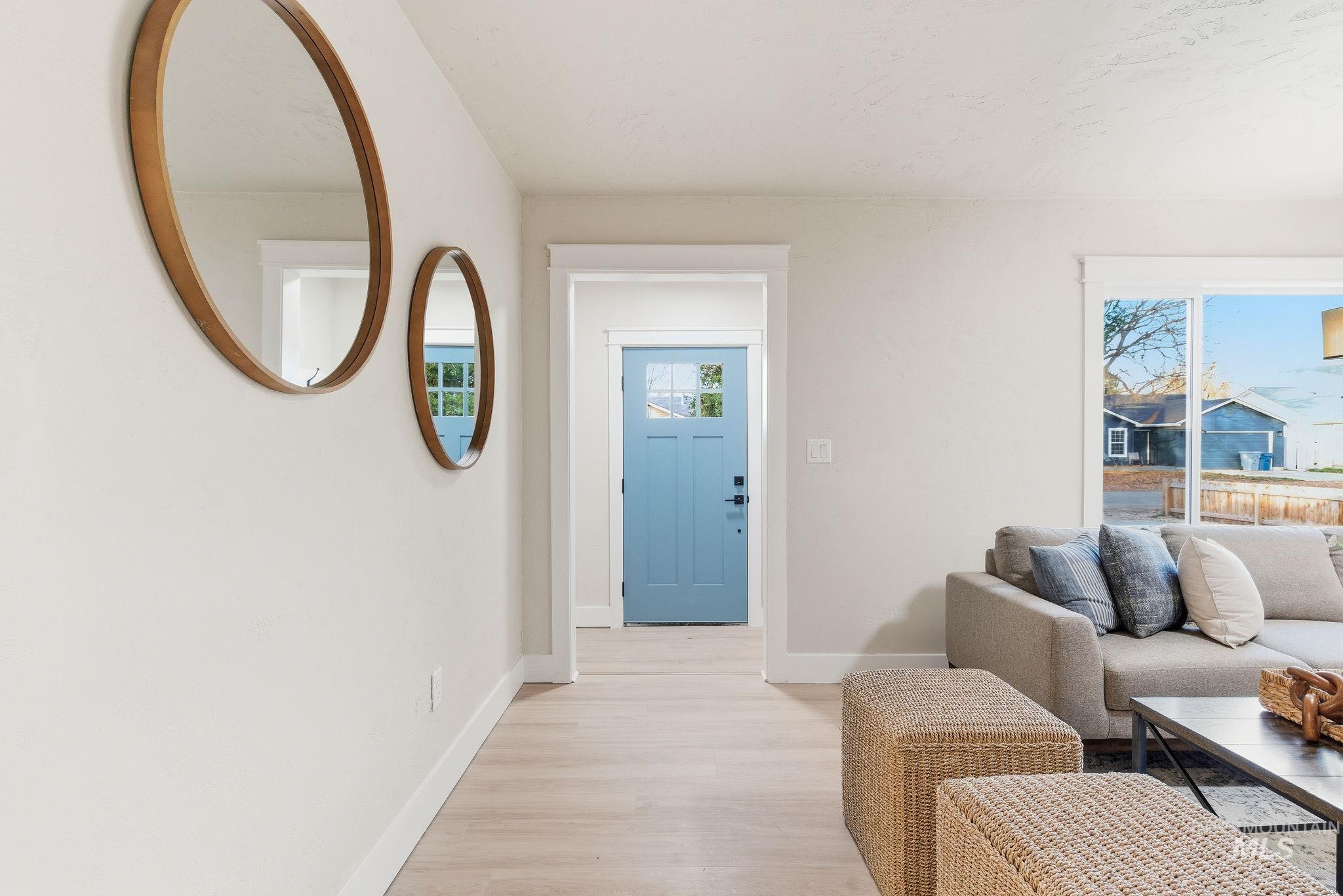 Foyer entrance featuring baseboards and light wood-style floors