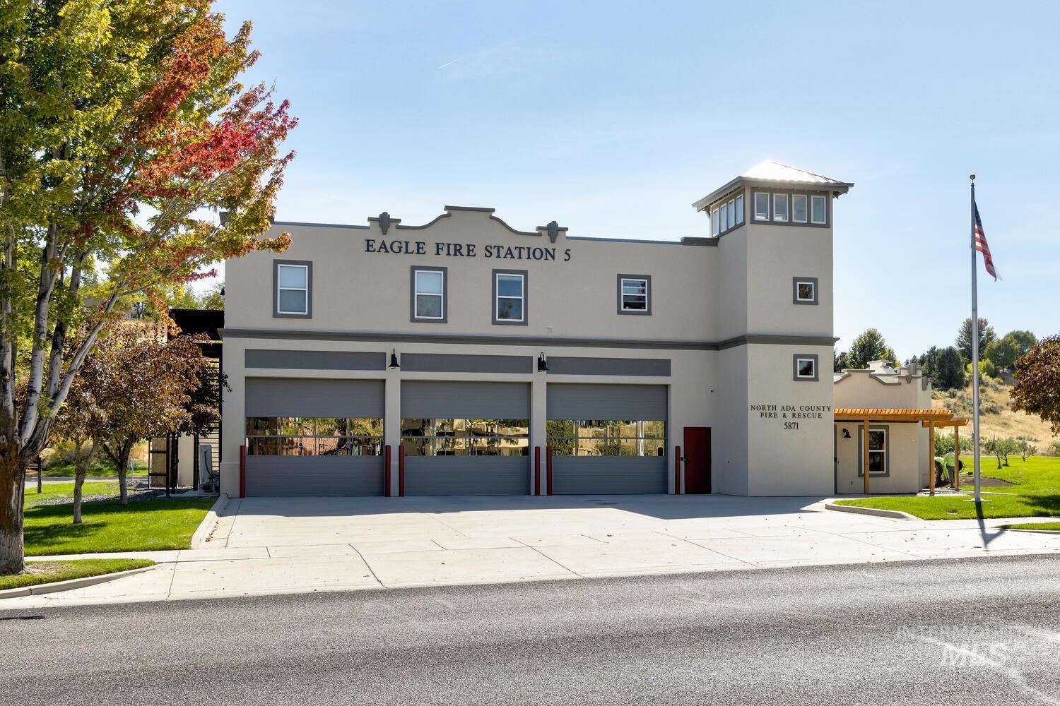 View of front facade with stucco siding, driveway, and a garage