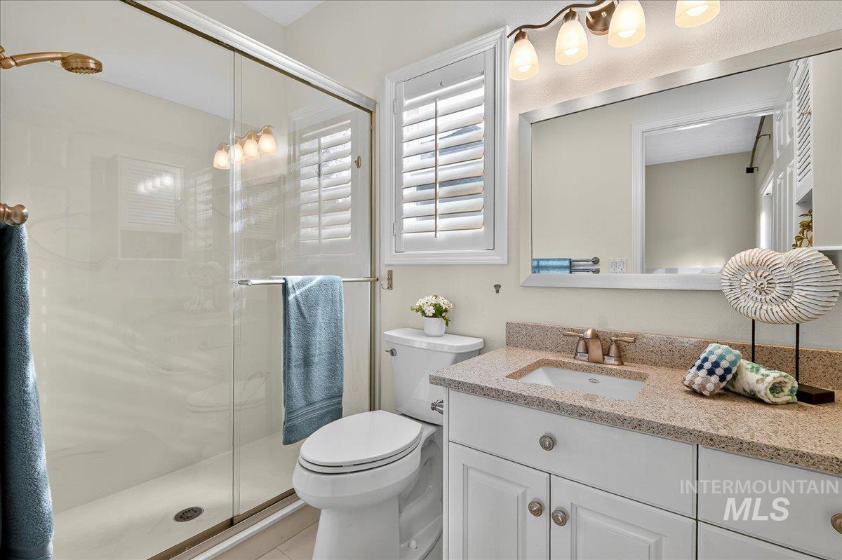 Bathroom with a shower stall and vanity
