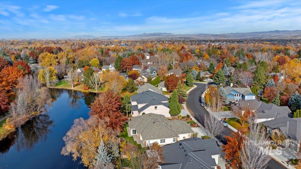View of property location featuring a water and mountain view and nearby suburban area
