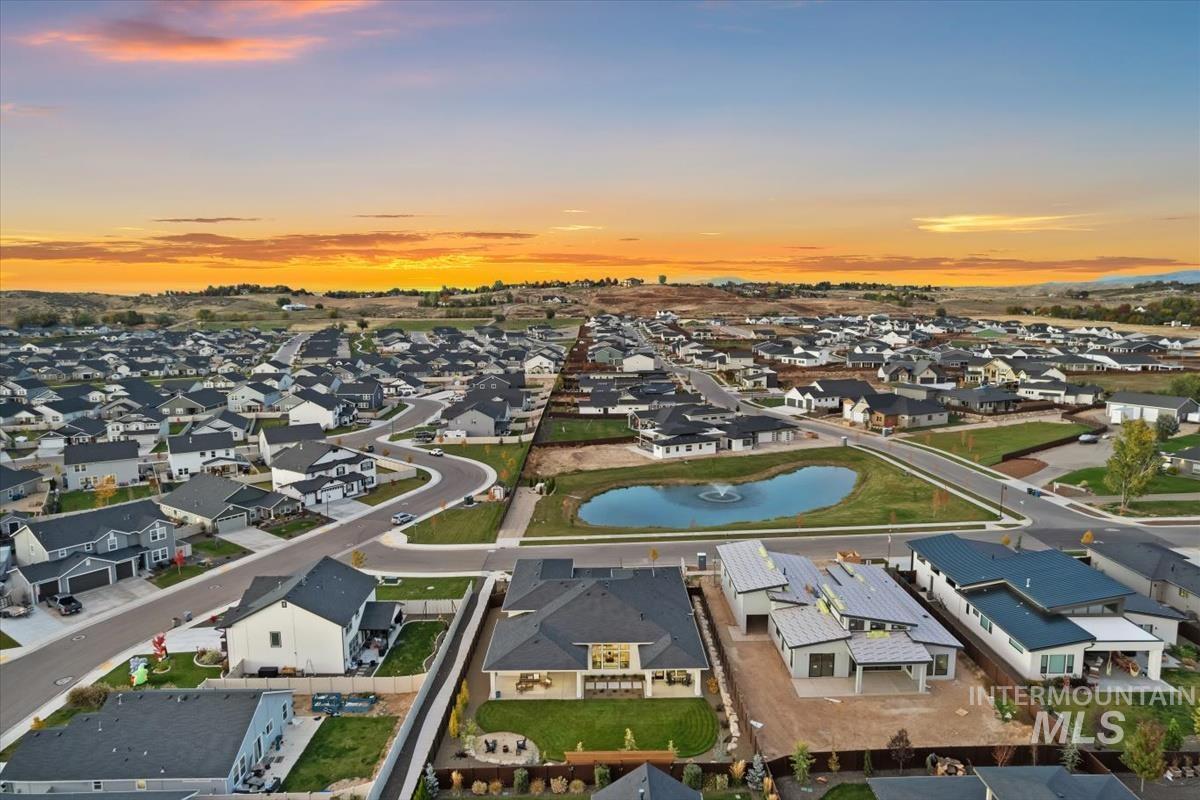 Aerial view at dusk of a water view and a residential view