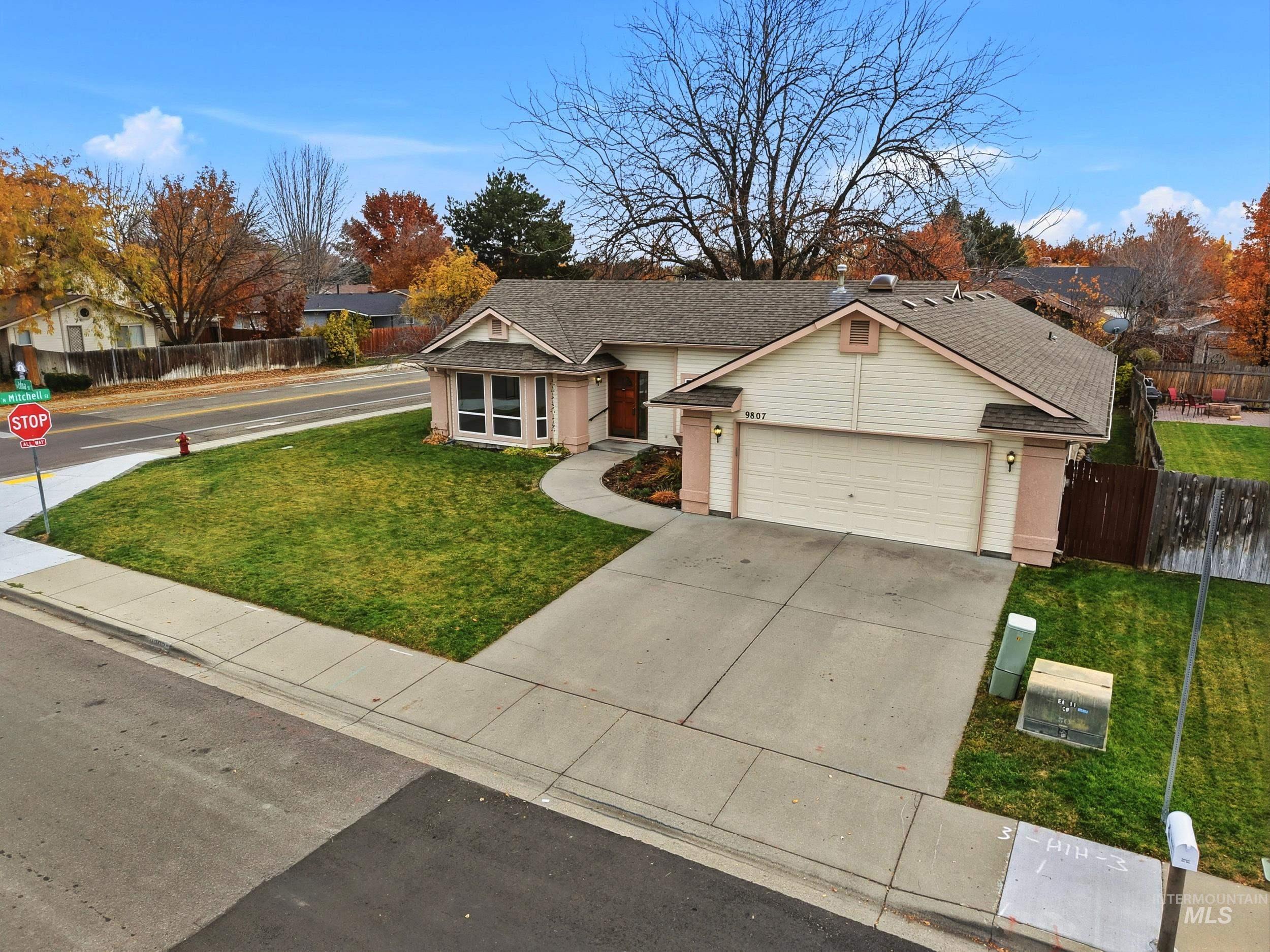 View of front of house featuring driveway, a shingled roof, and a garage