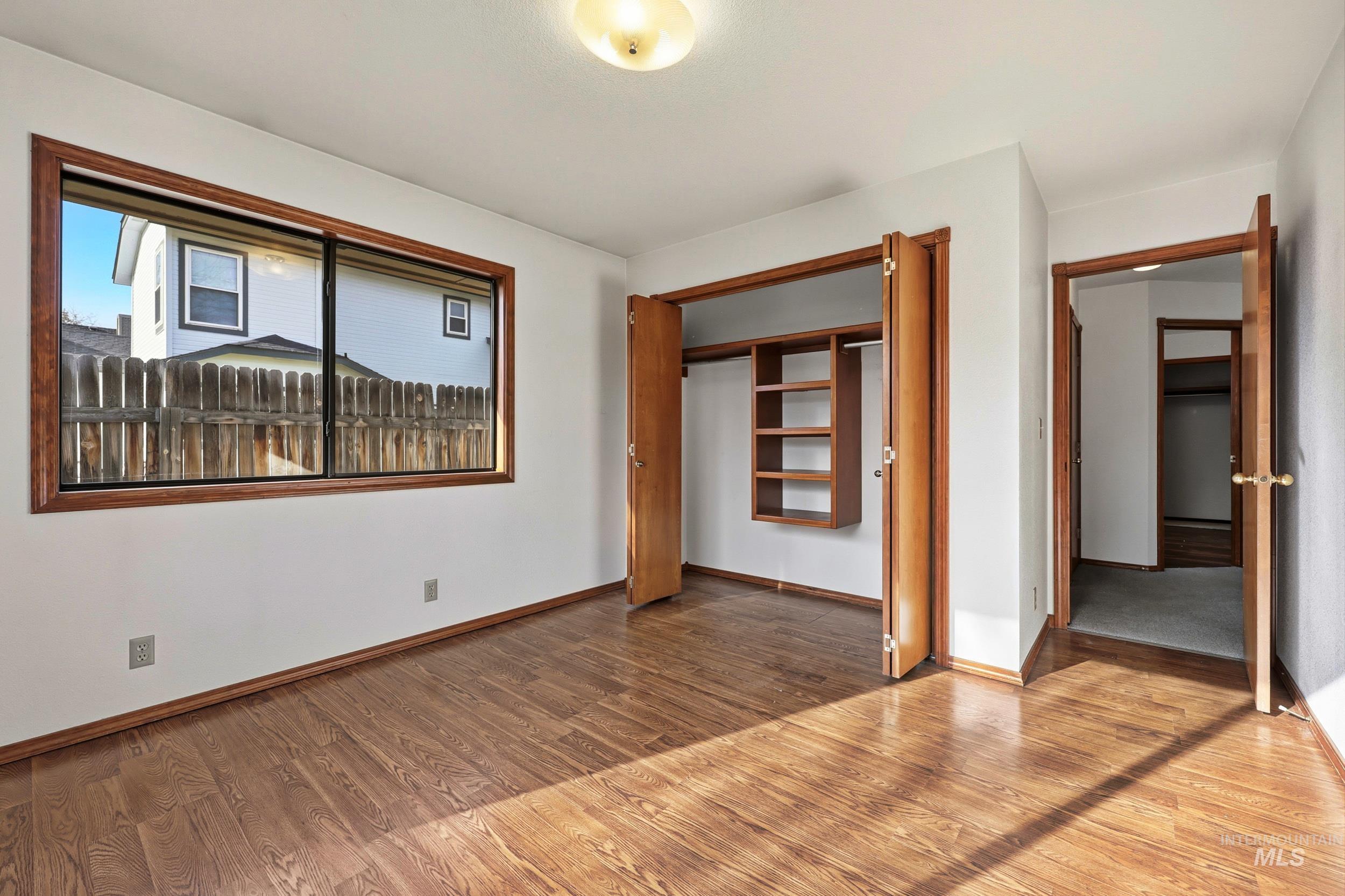 Unfurnished bedroom featuring wood finished floors and a closet