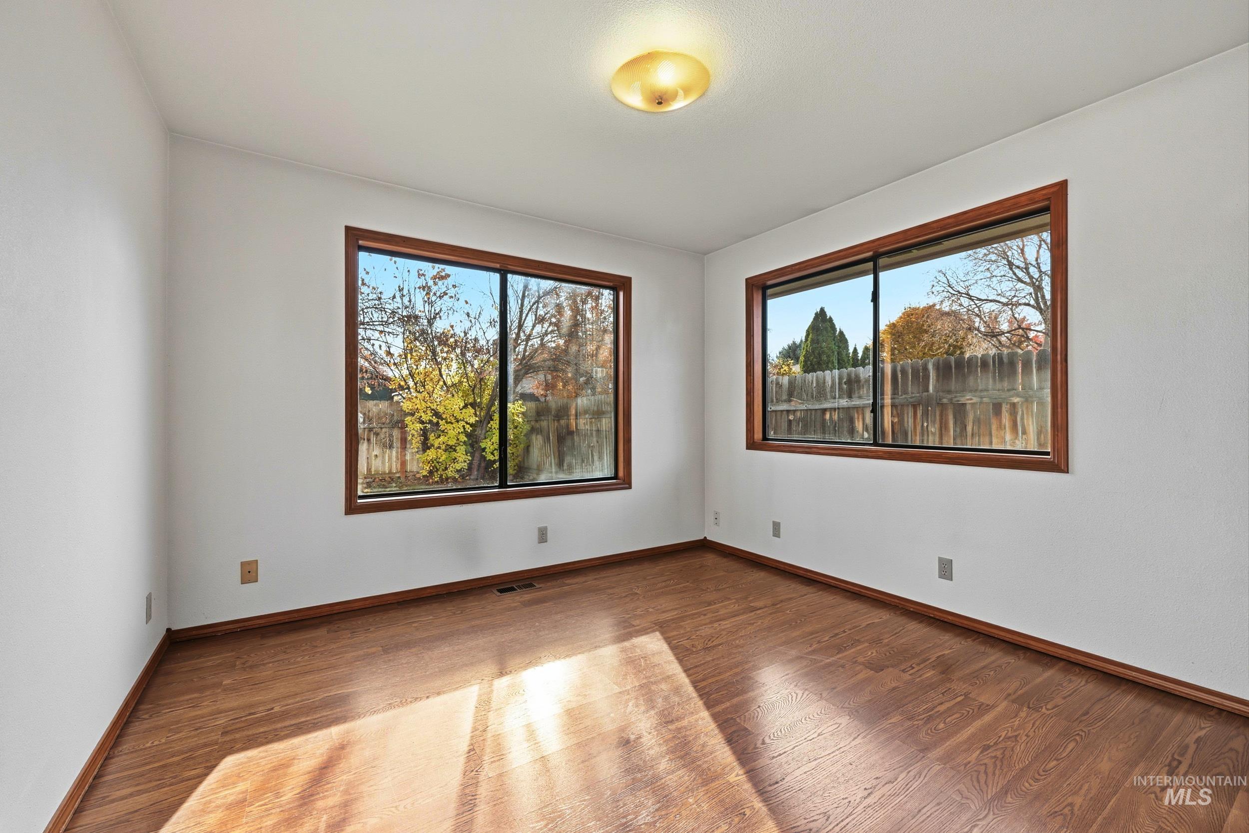 Spare room featuring wood finished floors