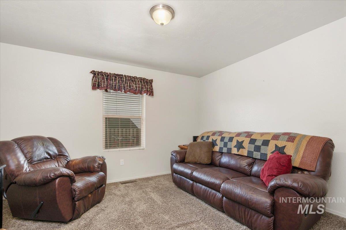 Living room featuring carpet floors and baseboards