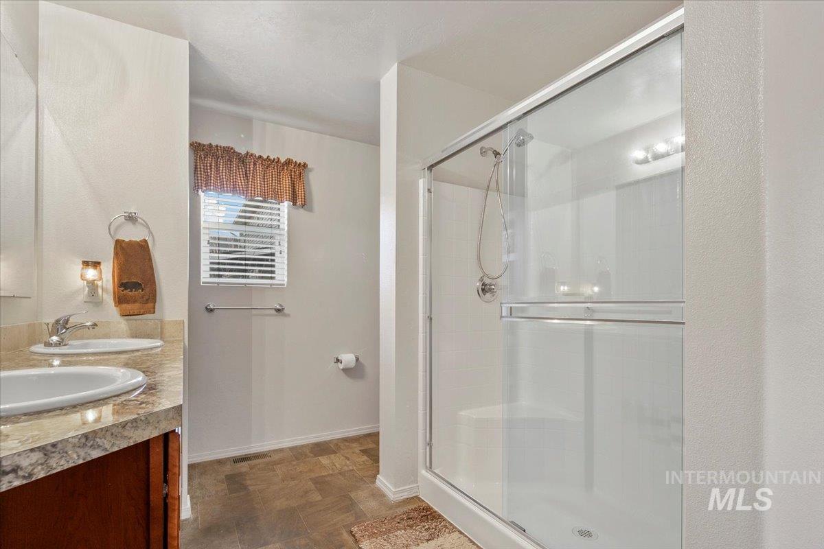 Bathroom with a stall shower and double vanity