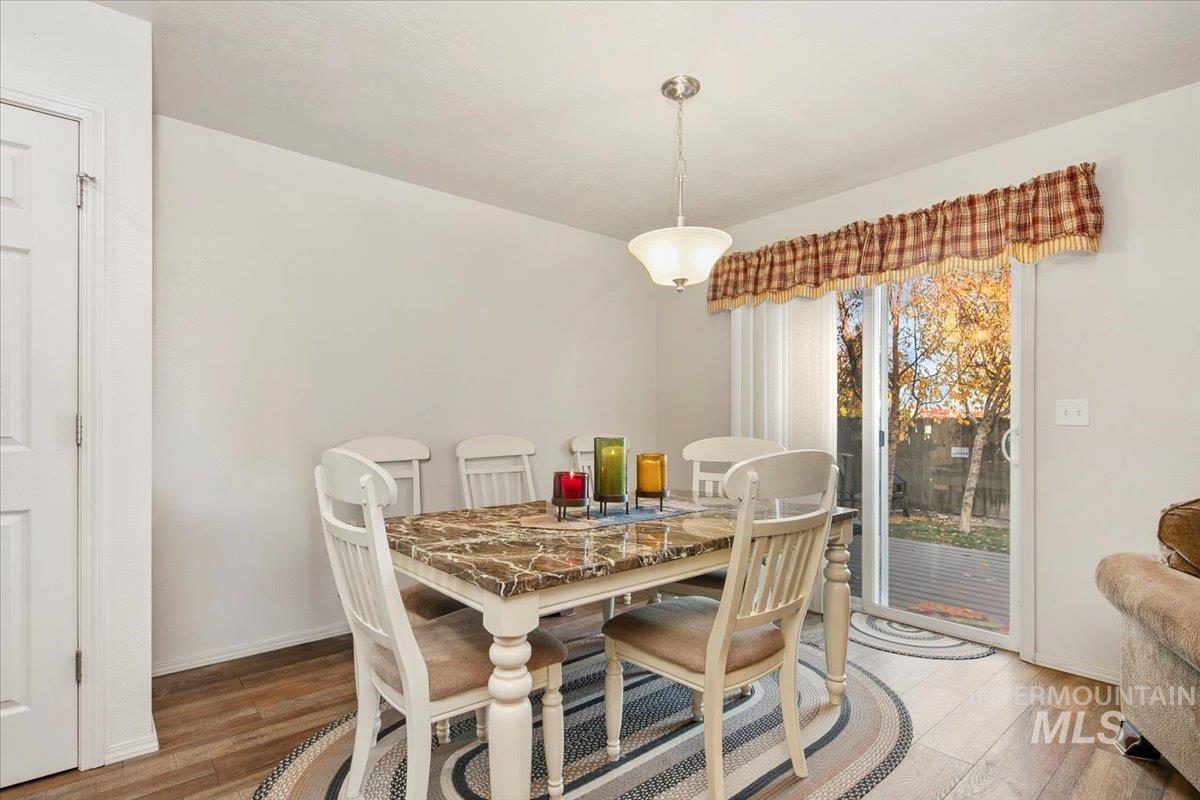 Dining space with light wood-type flooring and baseboards