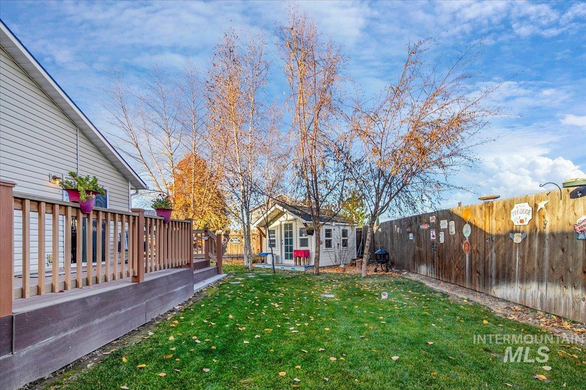 Fenced backyard with a wooden deck