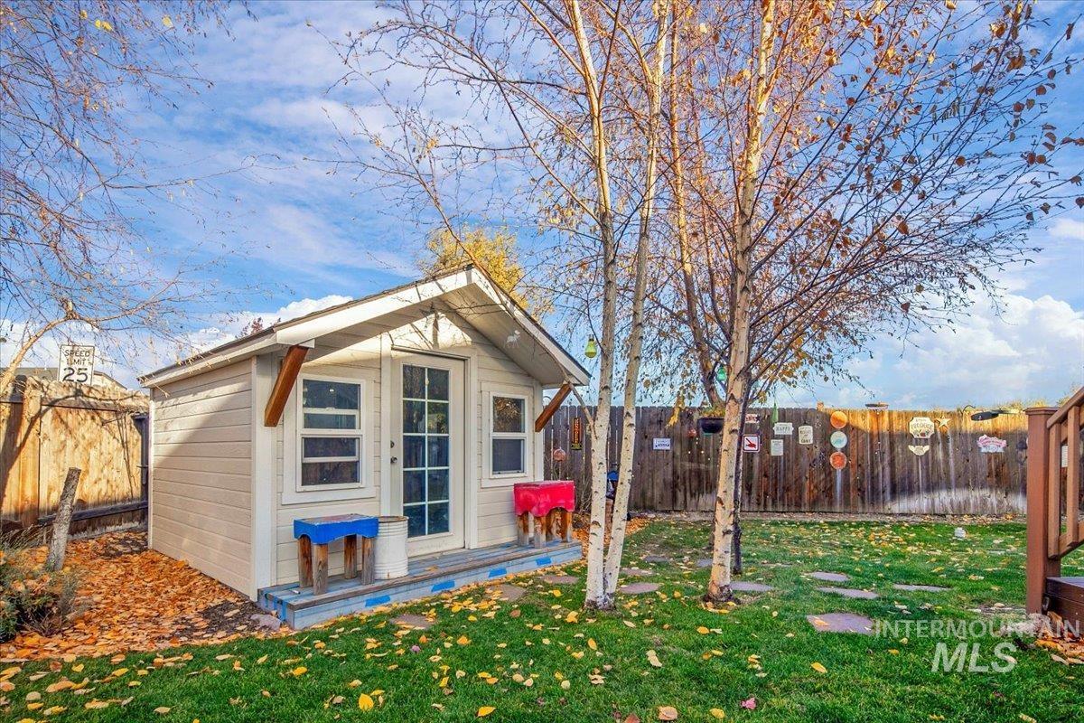 View of side of home featuring an outbuilding and a fenced backyard