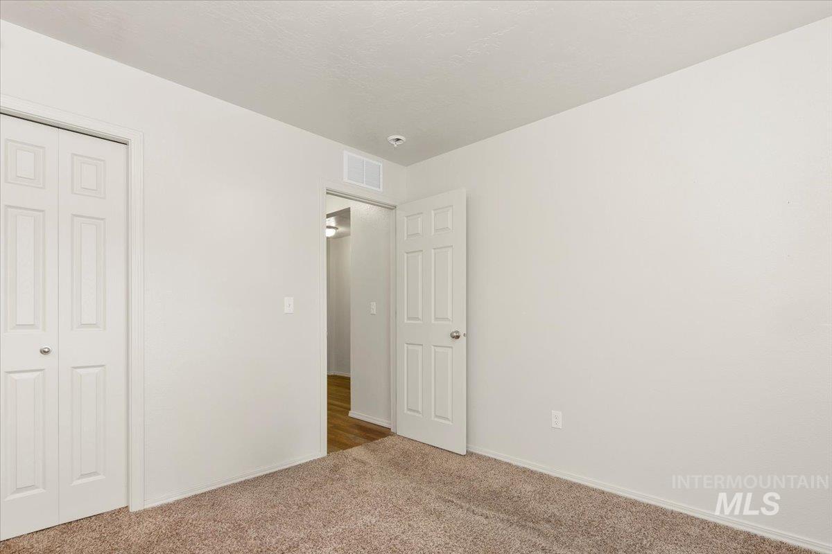 Unfurnished bedroom featuring carpet and a closet