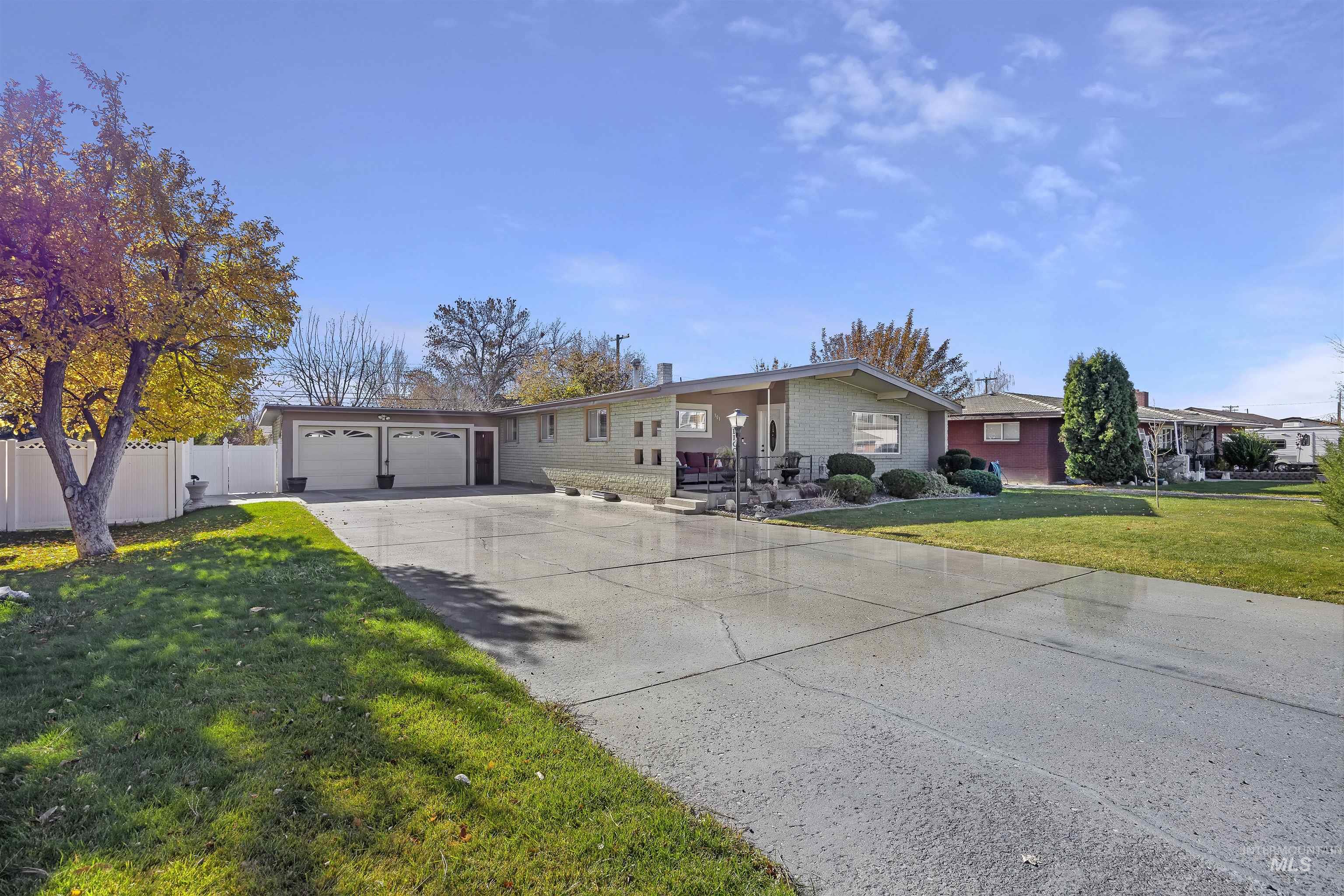 Ranch-style house featuring driveway and brick siding