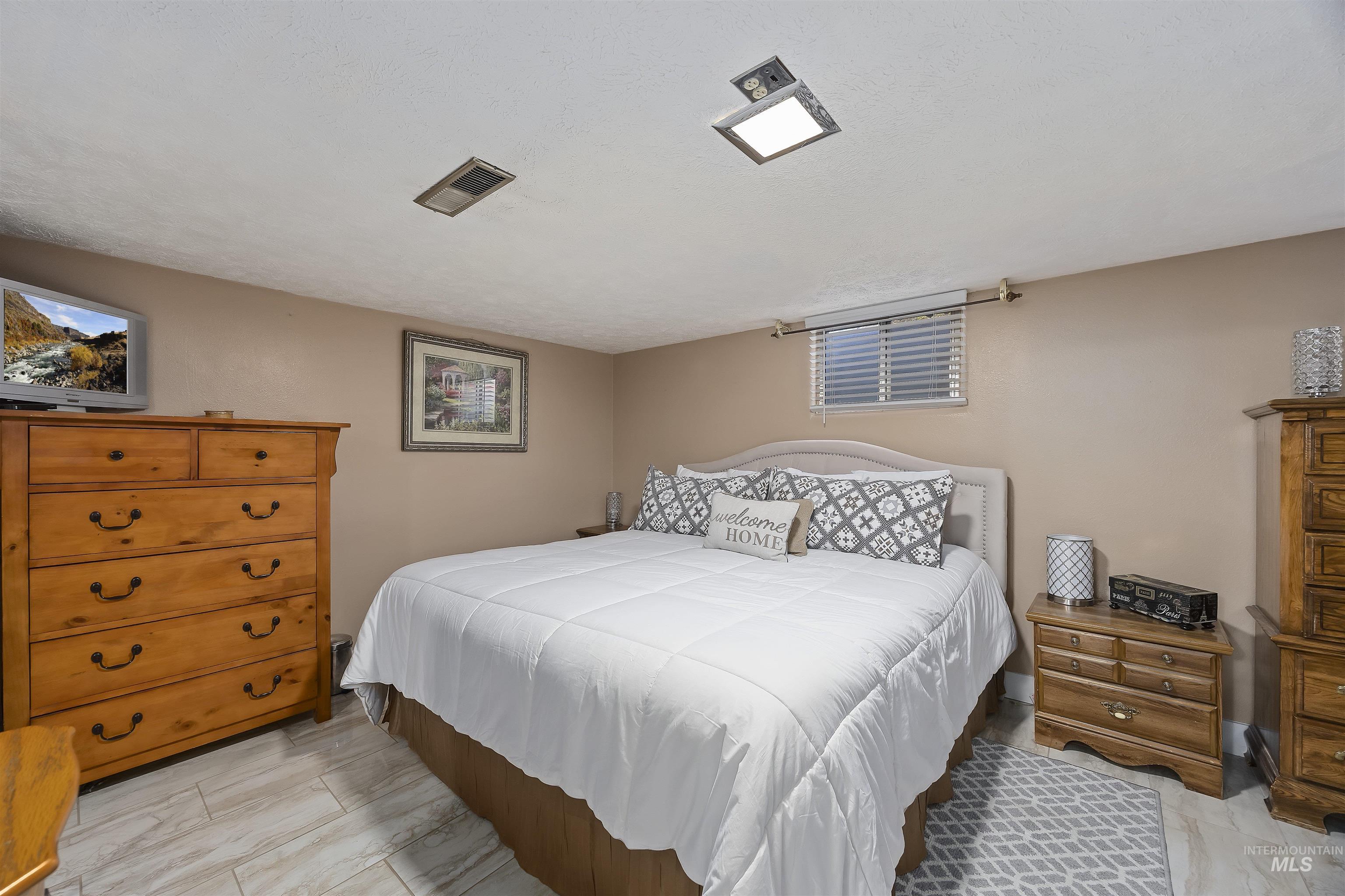 Bedroom with a textured ceiling