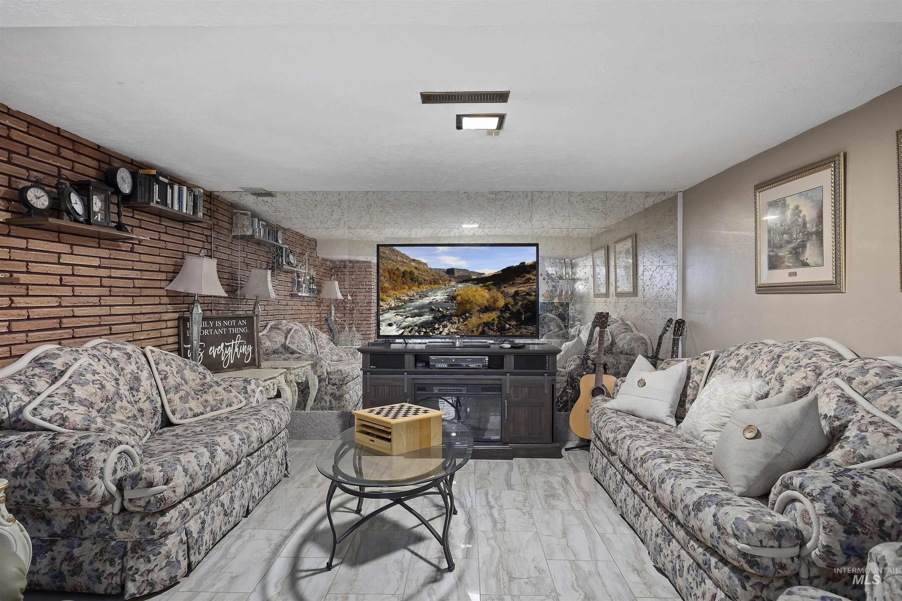 Living room featuring brick wall