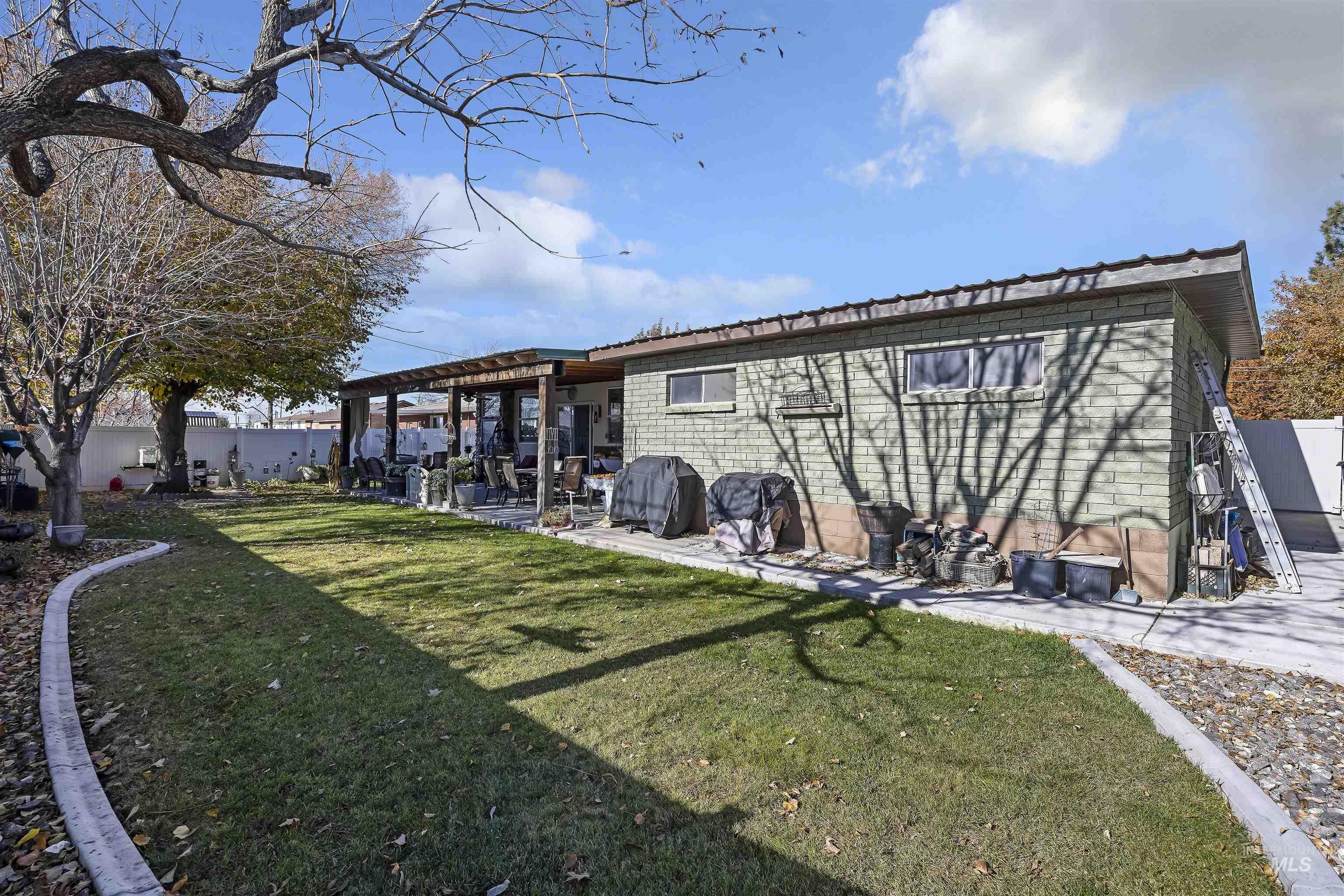 Back of house with a pergola, a patio area, and a metal roof