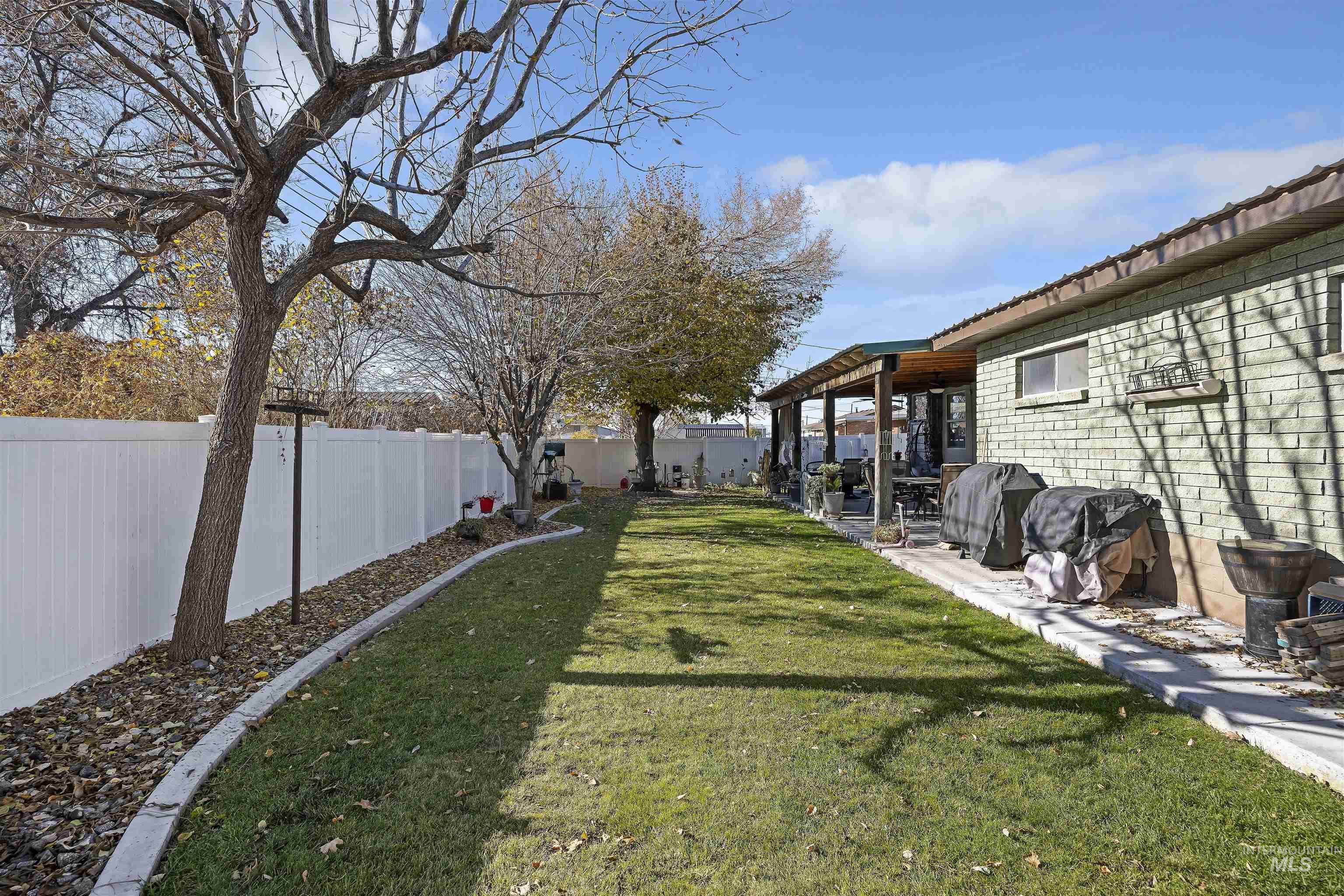 Fenced backyard with a patio and a pergola