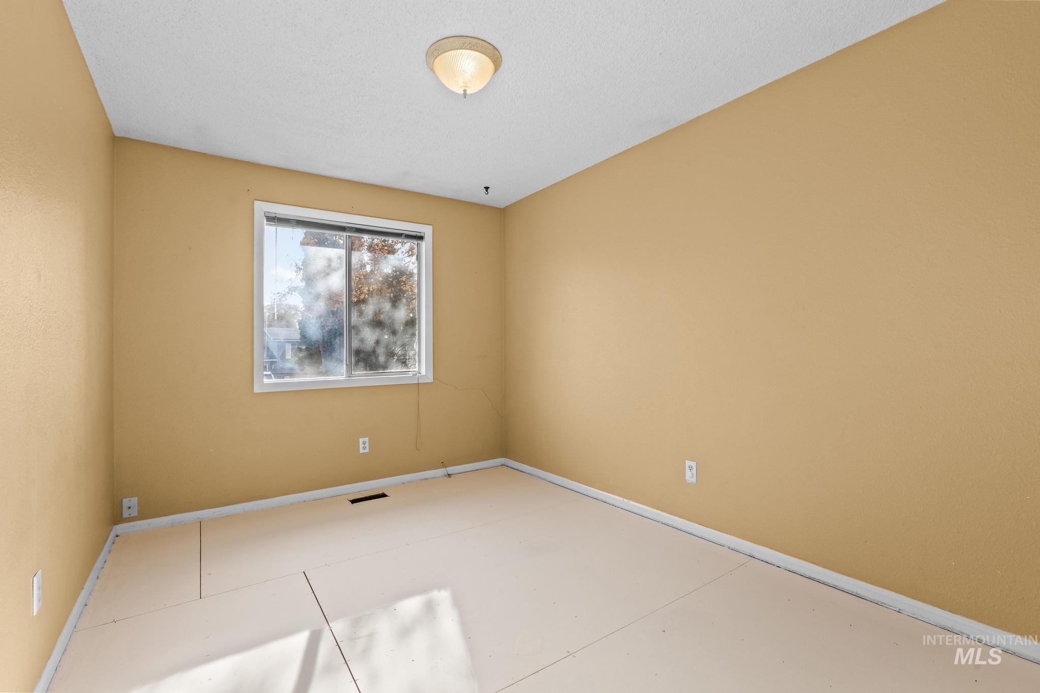 Unfurnished room with baseboards