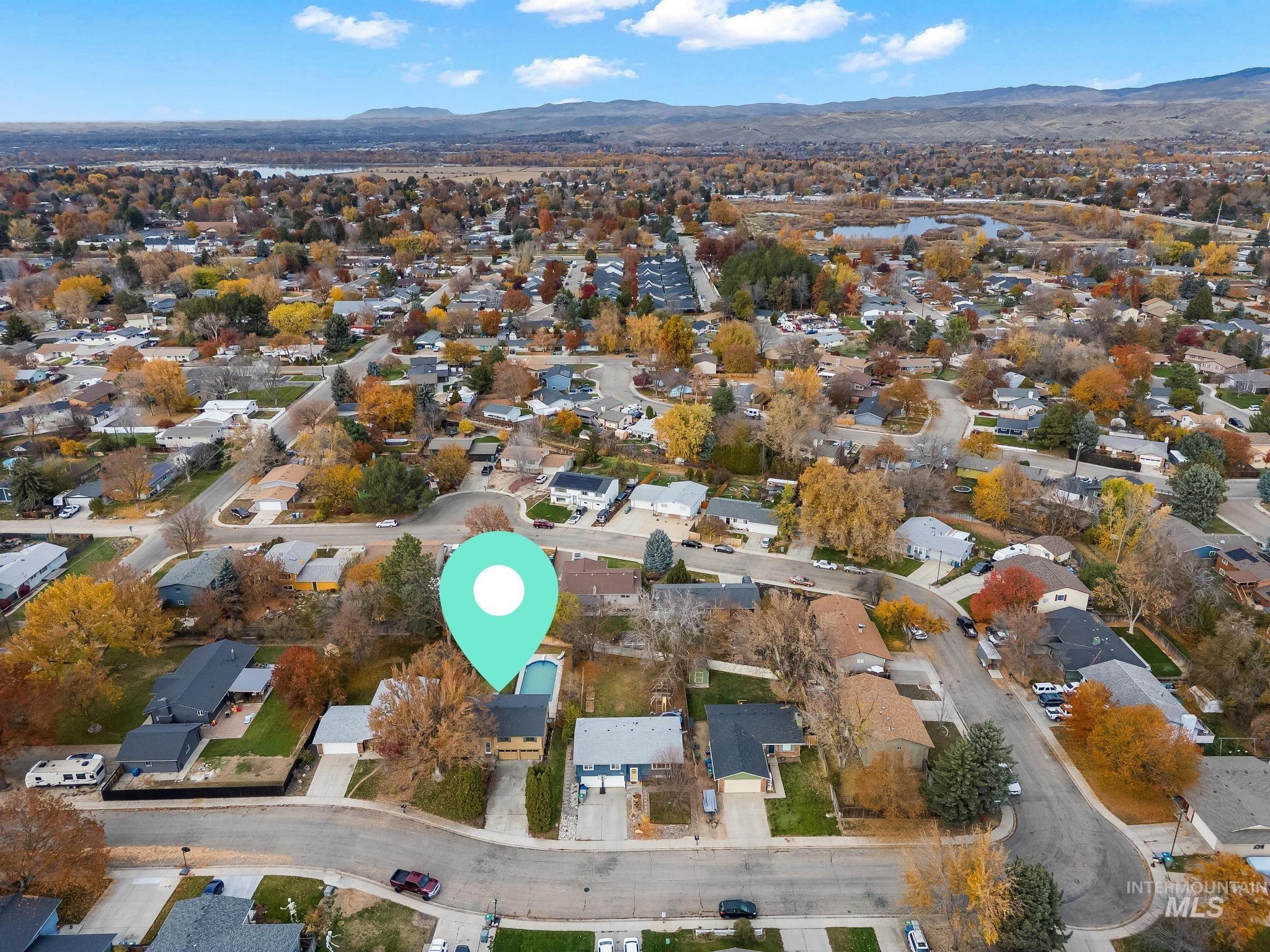 View of property location featuring nearby suburban area and a mountainous background