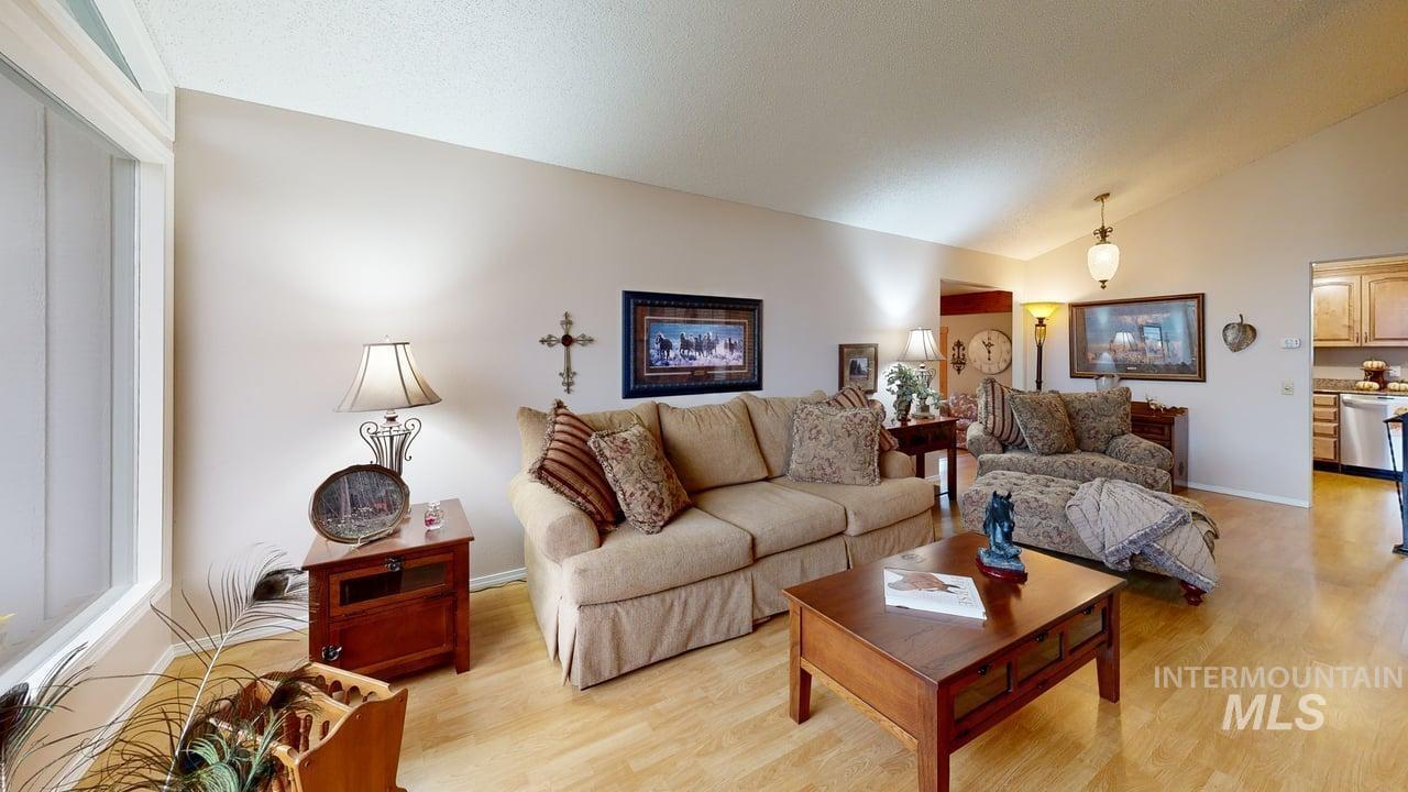 Living room with light wood-style floors and high vaulted ceiling