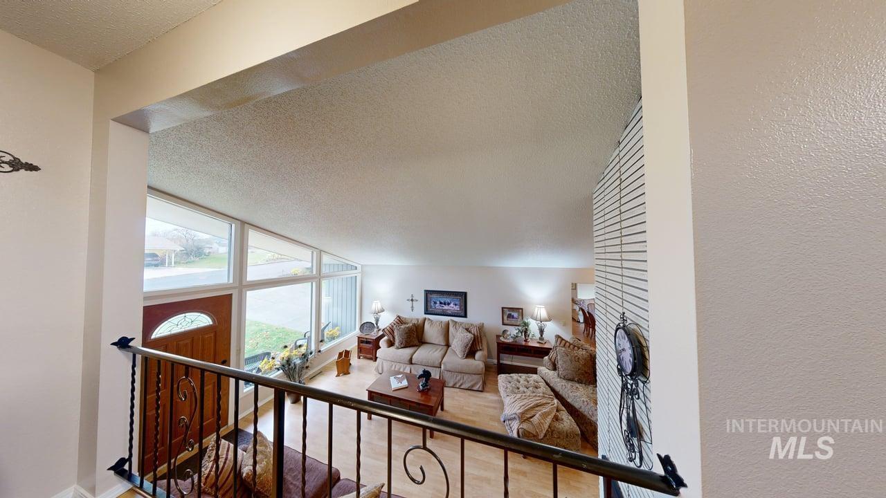 Living area with a textured ceiling and wood finished floors