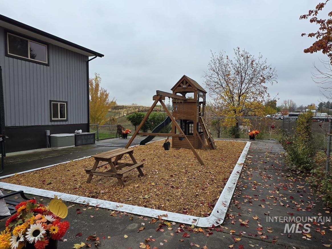 View of playground with a patio