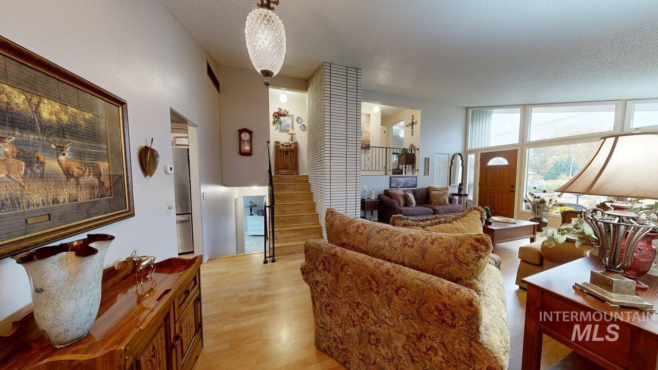 Living area featuring light wood-style flooring and a textured ceiling