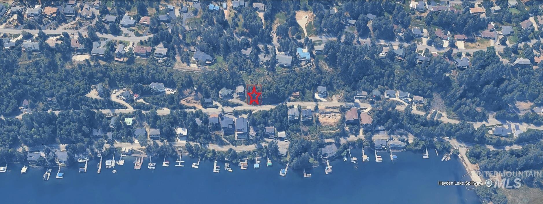 Aerial view of property and surrounding area with a nearby body of water
