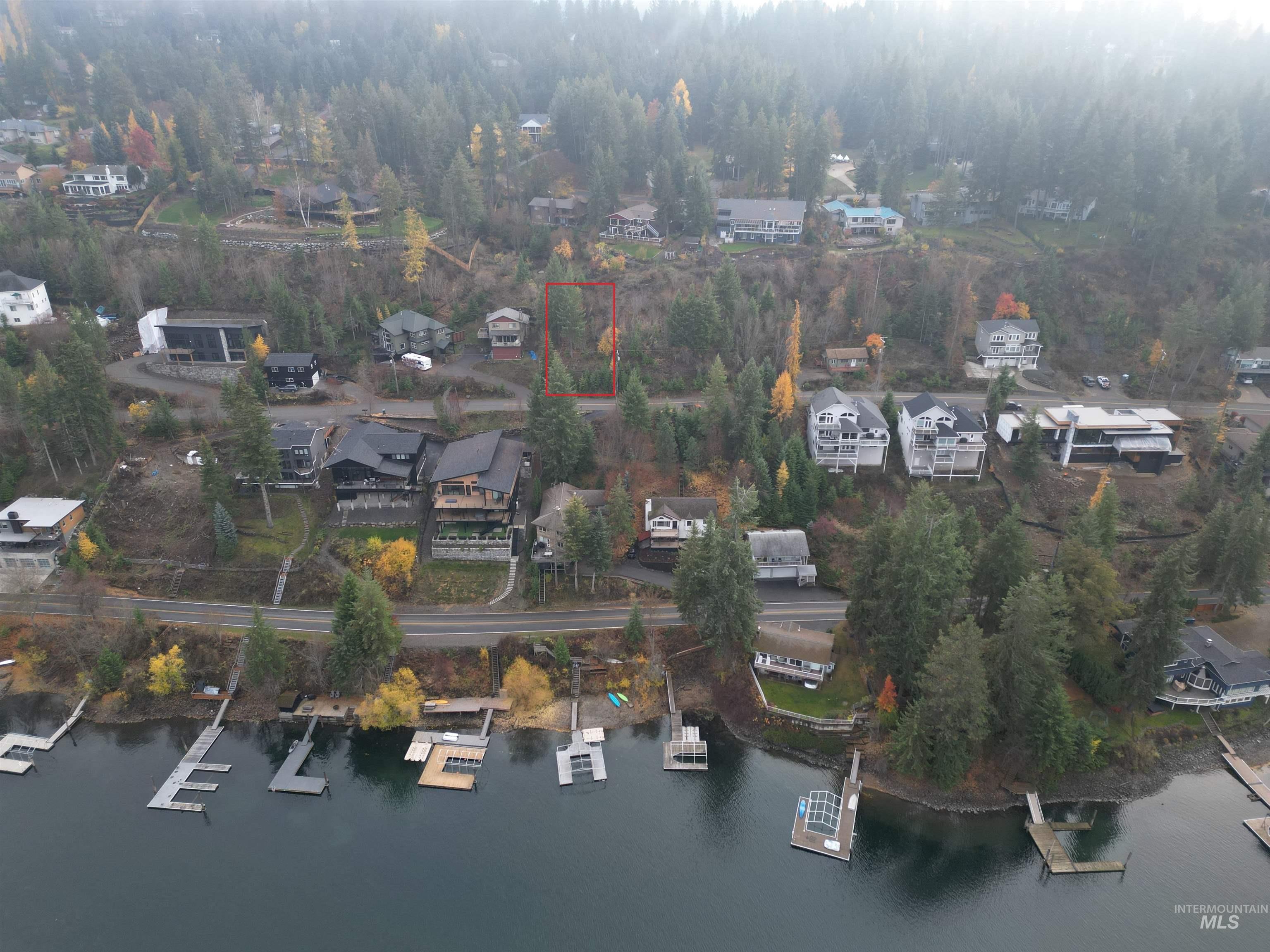 Aerial overview of property's location with nearby suburban area, property boundaries highlighted, and a large body of water