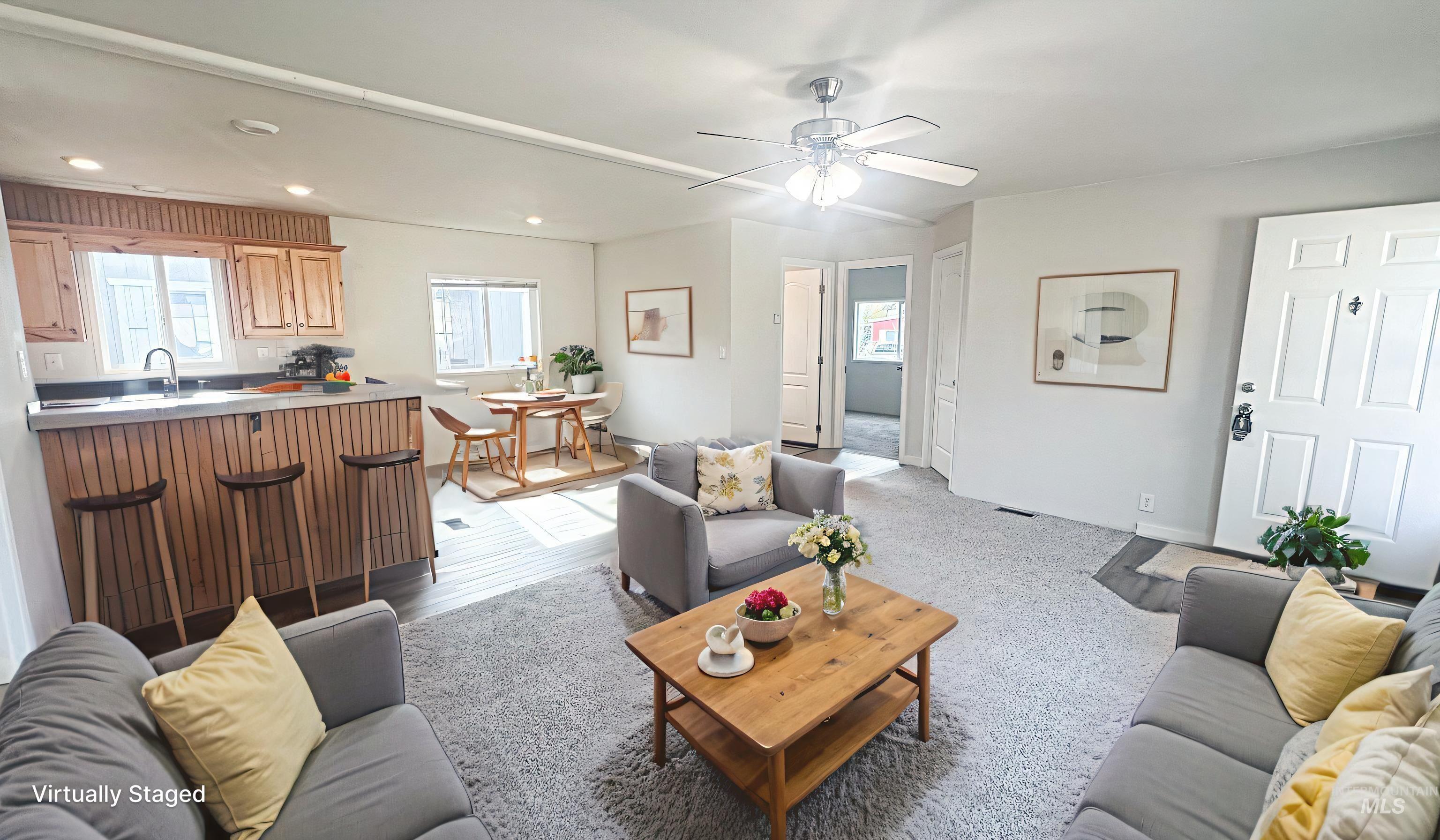 Living room with recessed lighting, a ceiling fan, and light wood-style floors
