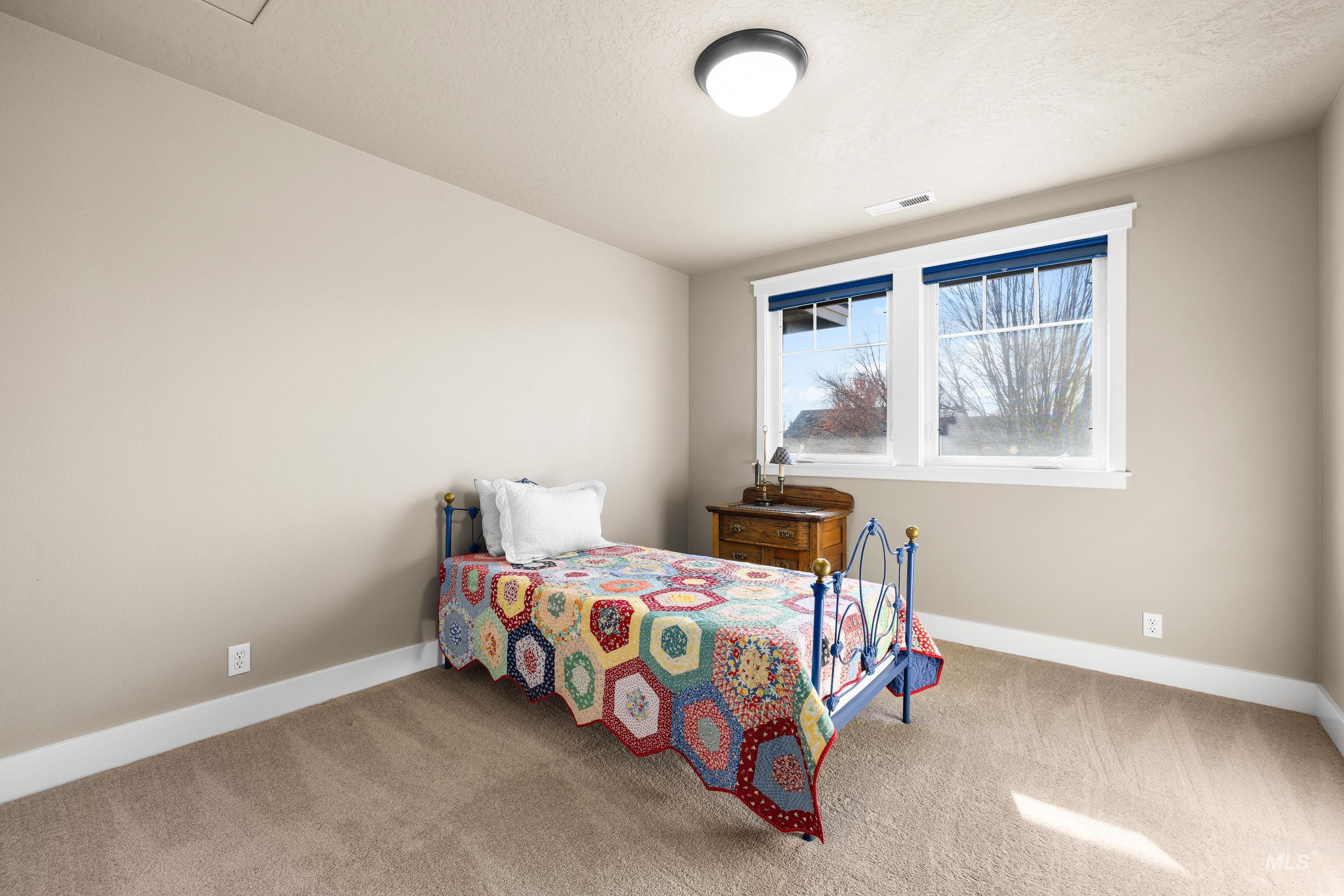 Bedroom featuring baseboards and carpet floors