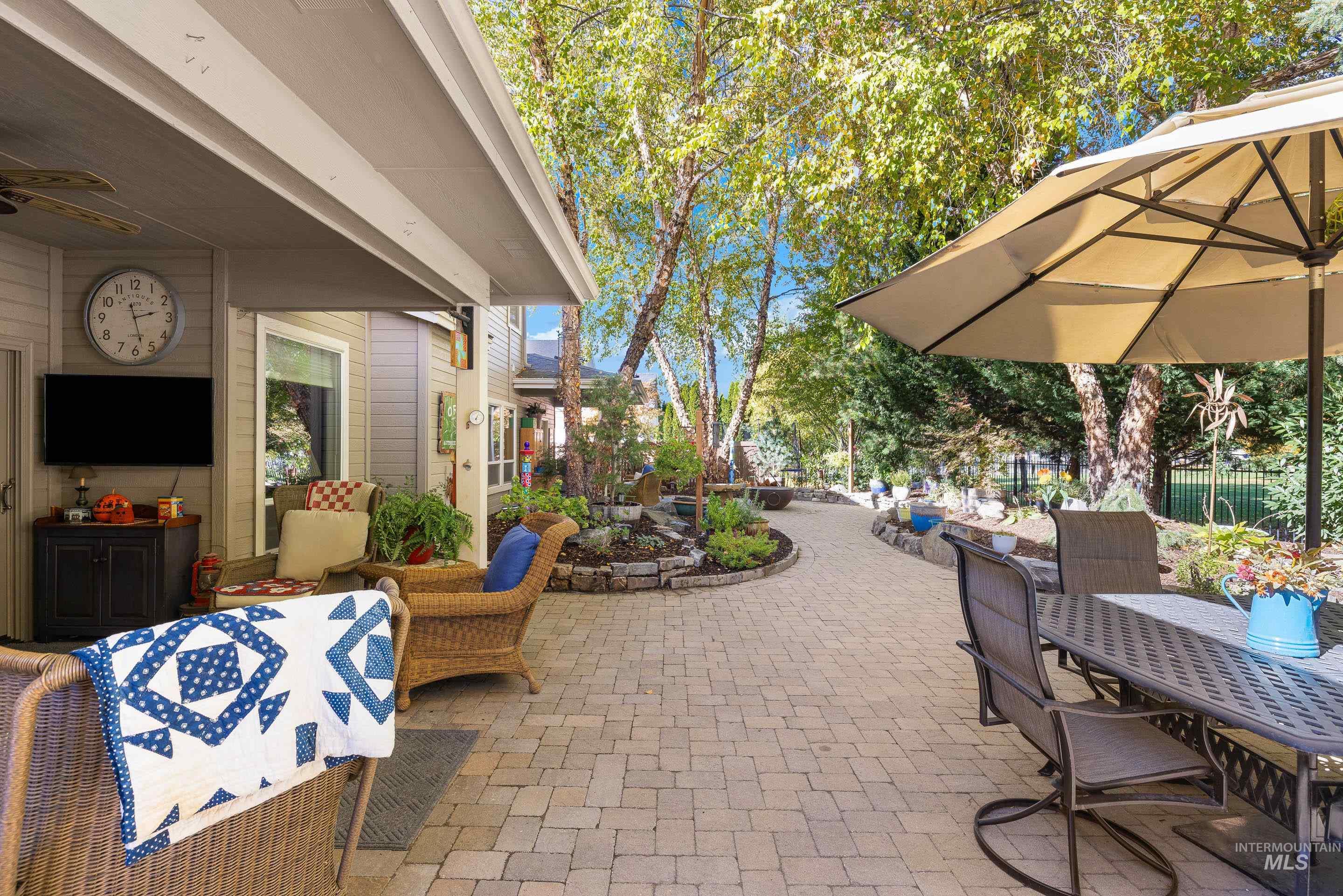 View of patio with ceiling fan and outdoor dining space